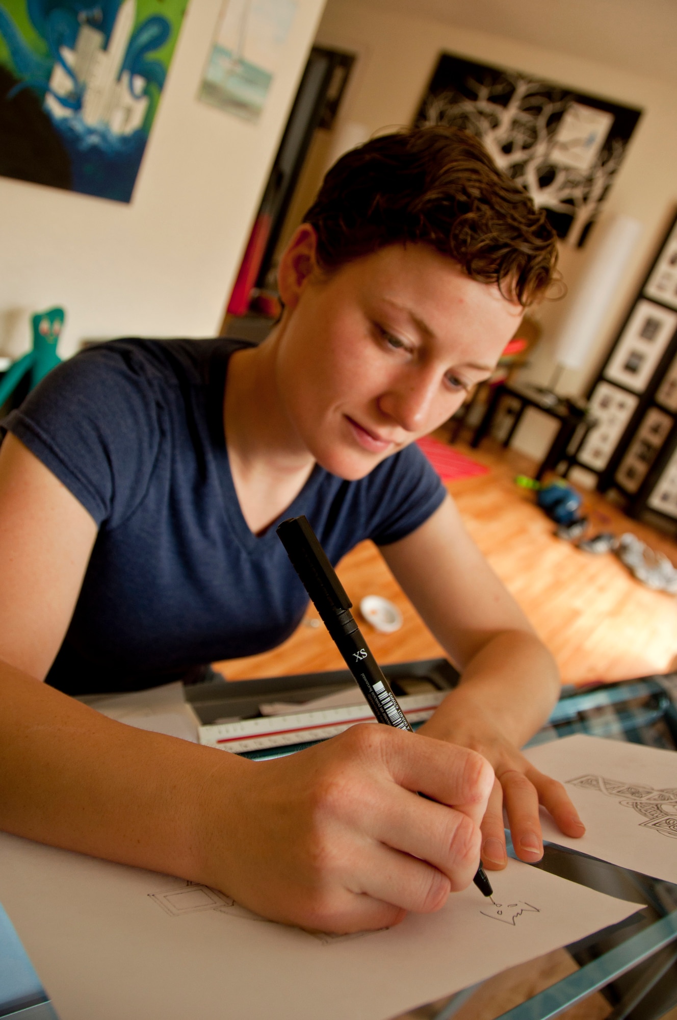 Airman 1st Class Jessilee Moore, 60th Aerial Port Squadron, draws April 16  at a table in her home. Moore often uses her creative talents as a cathartic outlet. (U.S. Air Force photo/Senior Airman Madelyn Brown)