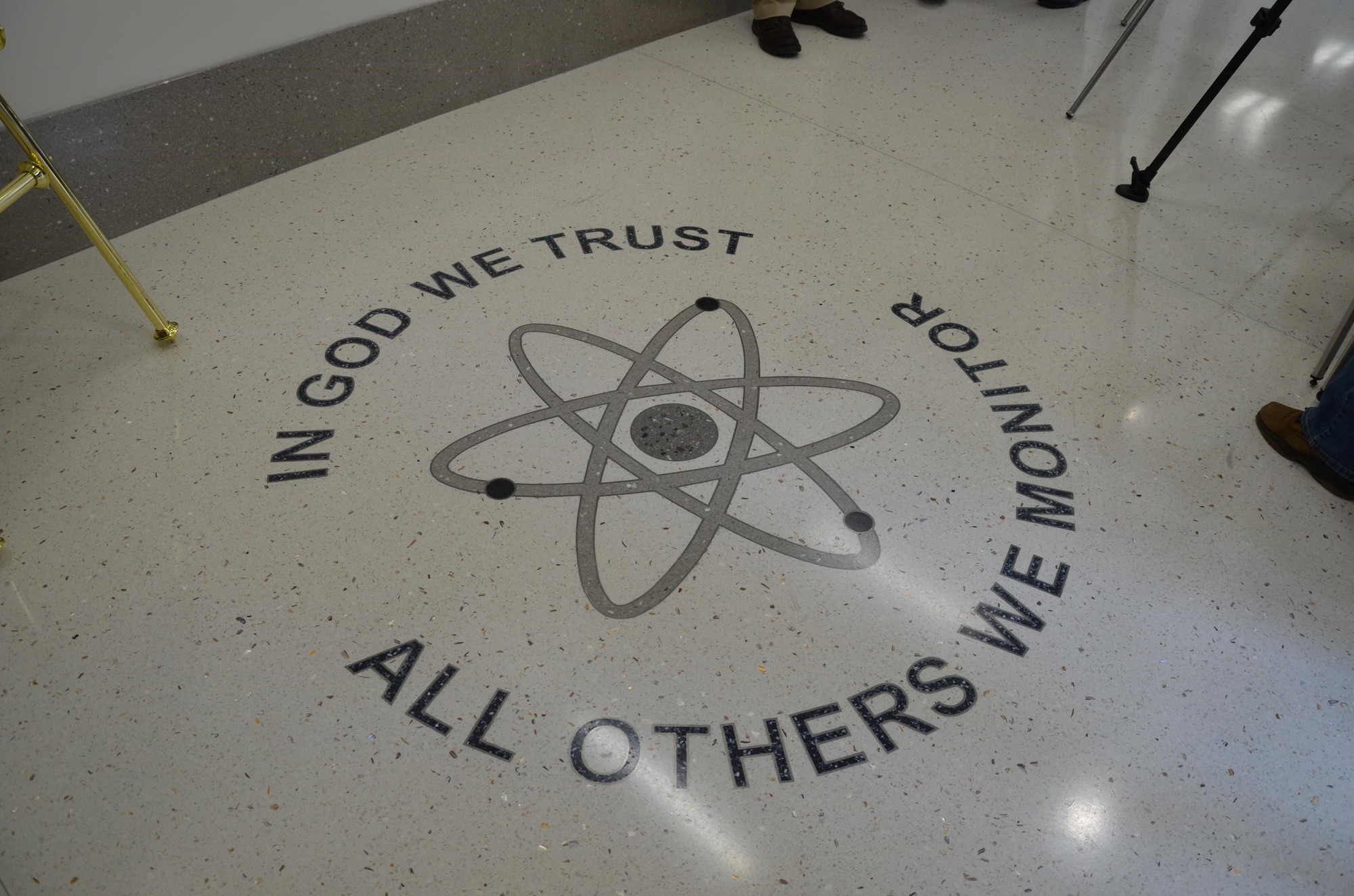 The motto “In God We Trust; All Others We Monitor” is displayed in the foyer of the Air Force Technical Applications Center’s new radiochemistry laboratory at Patrick AFB, Fla. The laboratory is a key component of the new four-structure campus, and will provide enhanced capabilities for AFTAC, the only Department of Defense organization tasked with monitoring nuclear treaty compliance. (U.S. Air Force photo/Susan Romano)