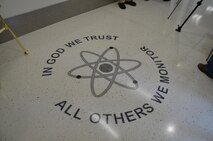 The motto “In God We Trust; All Others We Monitor” is displayed in the foyer of the Air Force Technical Applications Center’s new radiochemistry laboratory at Patrick AFB, Fla. The laboratory is a key component of the new four-structure campus, and will provide enhanced capabilities for AFTAC, the only Department of Defense organization tasked with monitoring nuclear treaty compliance. (U.S. Air Force photo/Susan Romano)