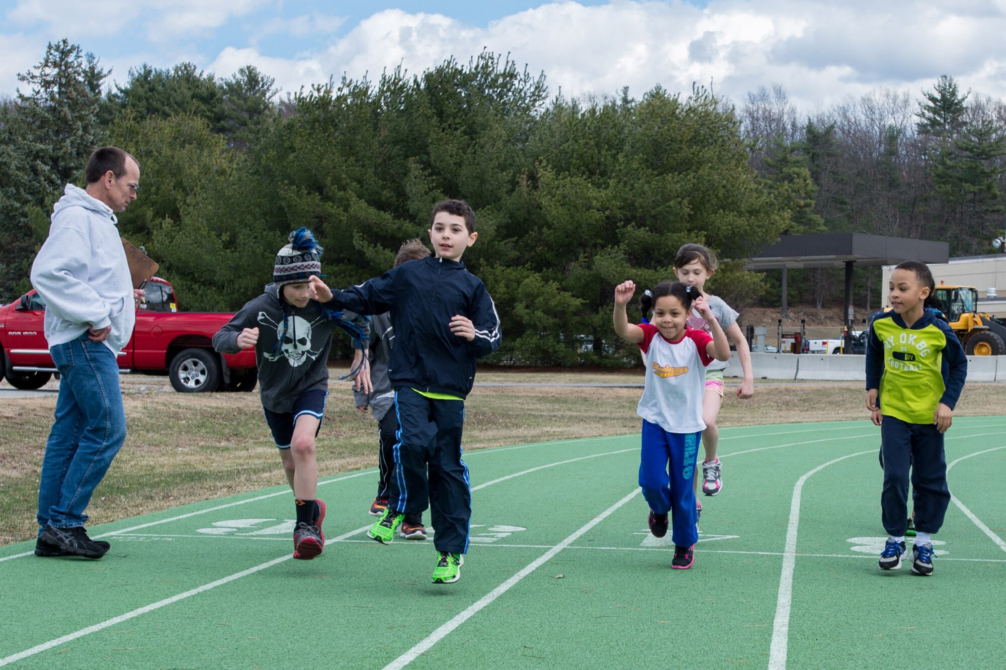 HANSCOM AIR FORCE BASE, Mass. – Steve Grant, 66th Force Support Squadron Fitness Center recreation specialist, coaches Hanscom youth ages nine to 14 at the base track April 9. Youth interested in participating the in the Hershey Youth Track Meet in June are invited to practice every Wednesday from 1:30 to 2:30 p.m. and Saturday from 9 to 10 a.m. at the track. Events include running, standing long jump and throwing. Participants do not have to come to every practice to enter the meet. For more information contact the Fitness Center at 781-225-6630. (U.S. Air Force photo by Rick Berry)