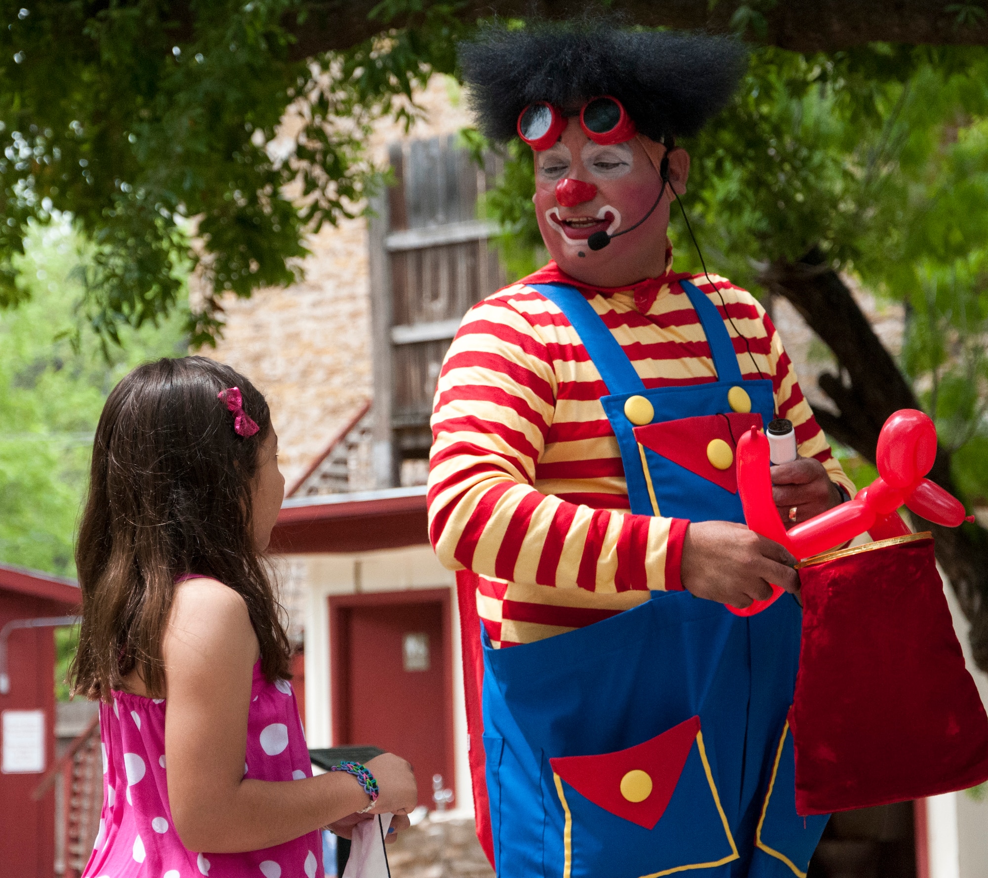 Buttons the Clown attempts to make a balloon animal disappear for a child at the Whitehead Memorial Museum in Del Rio, Texas, April 12, 2014. The act was showcased for kids from Pathways Children Shelter during an Easter celebration by Leadership Del Rio. (U.S. Air Force photo/Airman 1st Class Jimmie D. Pike/Released)