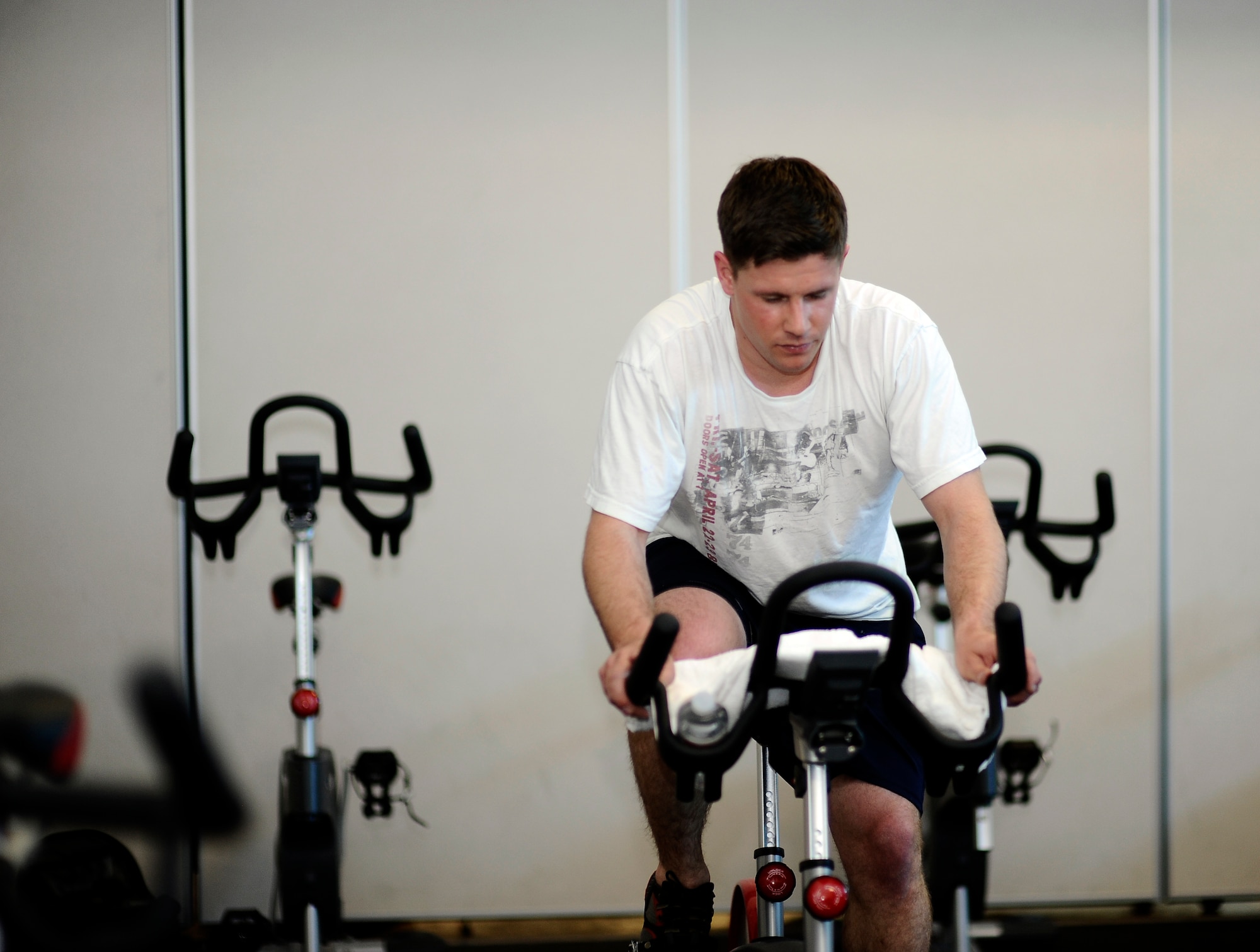 Senior Airman Michael Satterelli, 460th Space Wing executive assistant, cycles during Buckley’s annual Spin-A-Thon, April 11, 2014, at the fitness center on Buckley Air Force Base, Colo. Every hour, one person from each 460th Space Wing unit participated in a 45-minute spin class, competing for Commander’s Cup points. (U.S. Air Force photo by Airman 1st Class Samantha Saulsbury/Released)