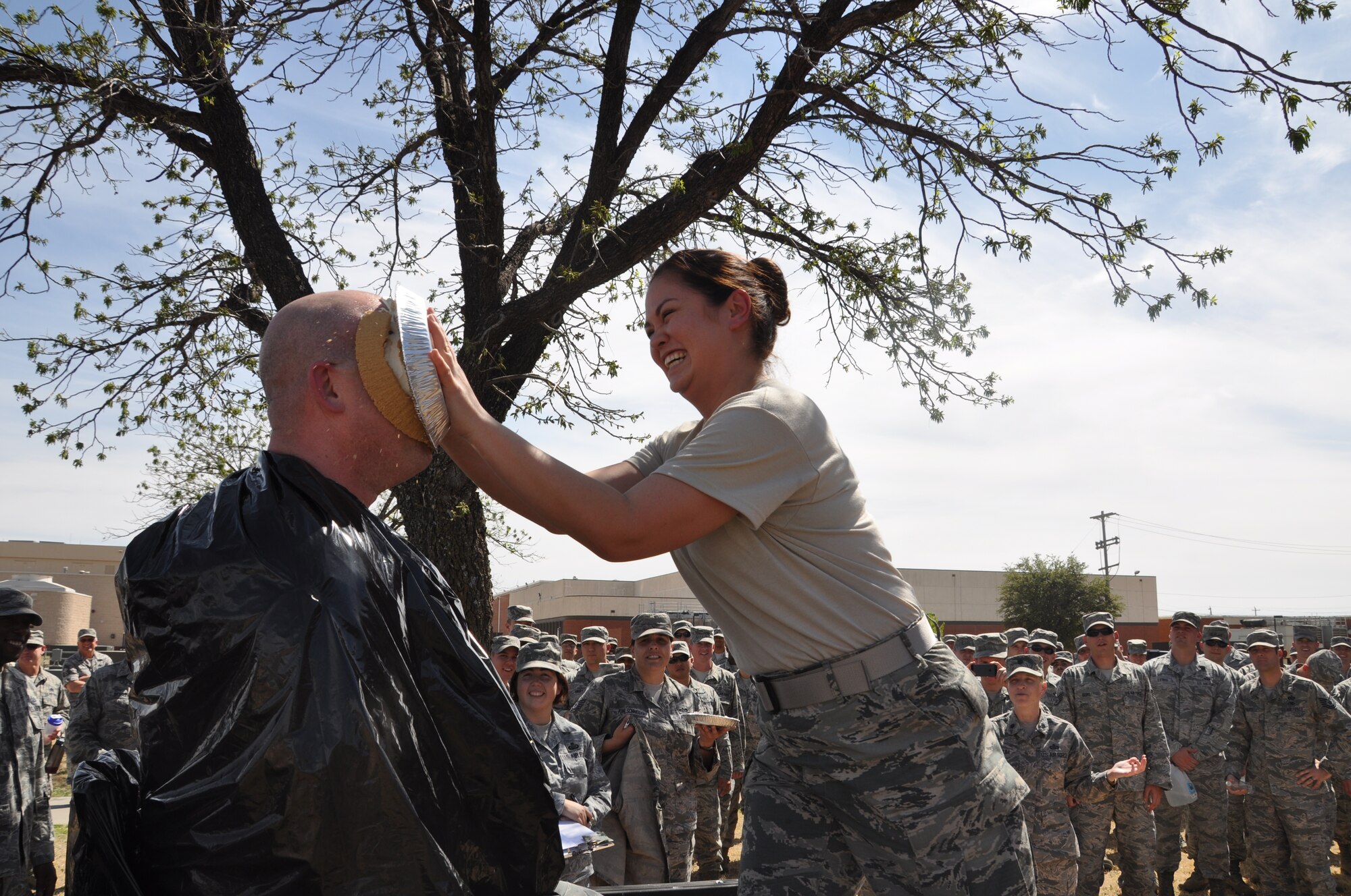 GOODFELLOW AIR FORCE BASE, Texas – Staff Sgt. Kimberly C. Honeycutt, 315th Training Squadron instructor, smashes a pie into Master Sgt. Robert L. Miller, 315th TRS instructor, outside the 315th TRS during an Air Force Assistance Fund event here Aug. 11. A pie in the face contest was held to help raise money for the AFAF. (U.S. Air Force photo/ Tech. Sgt. Jared Whitecar)