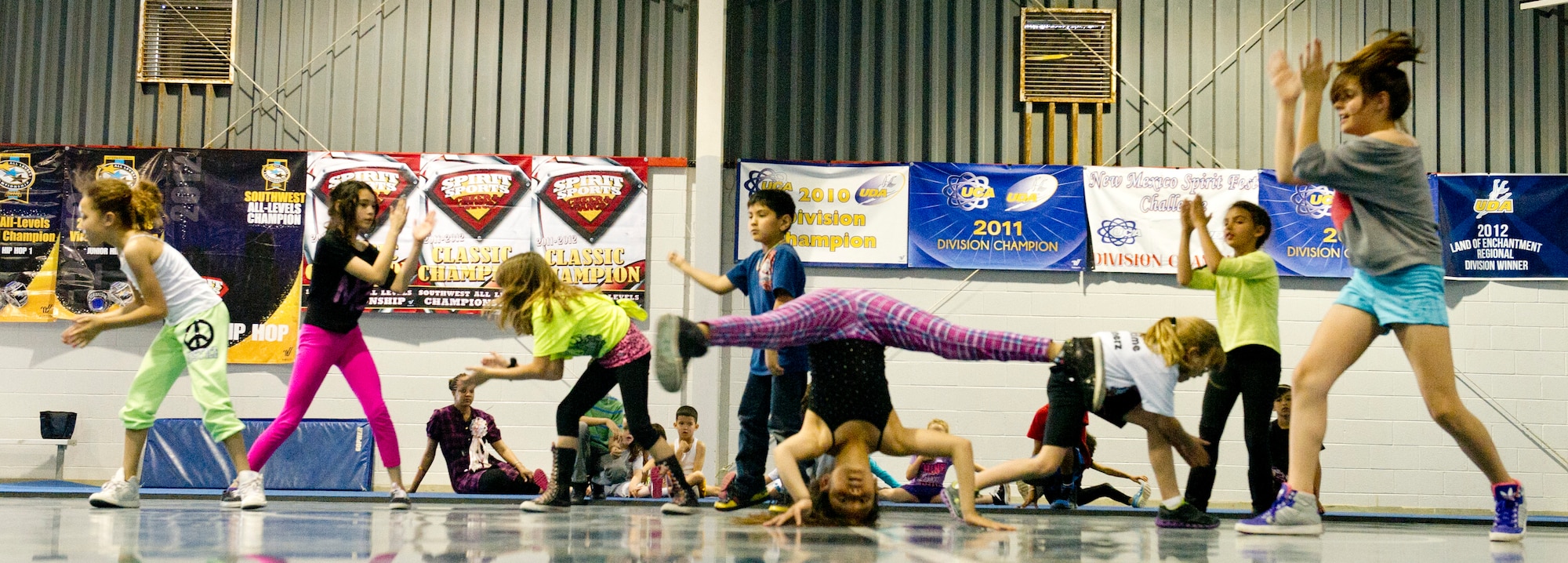 Military children who dance at Showtime Studio show off their skills while practicing for competition at the Boys and Girls Club in Alamogordo, N.M., April  9. April is recognized as the Month of the Military Child. This month highlights the contributions military children make as their parents serve our country. The children of Showtime Studio have won over 20 national titles competing in the hip-hop dance category. (U.S. Air Force photo by Airman 1st Class Leah Ferrante/Released)