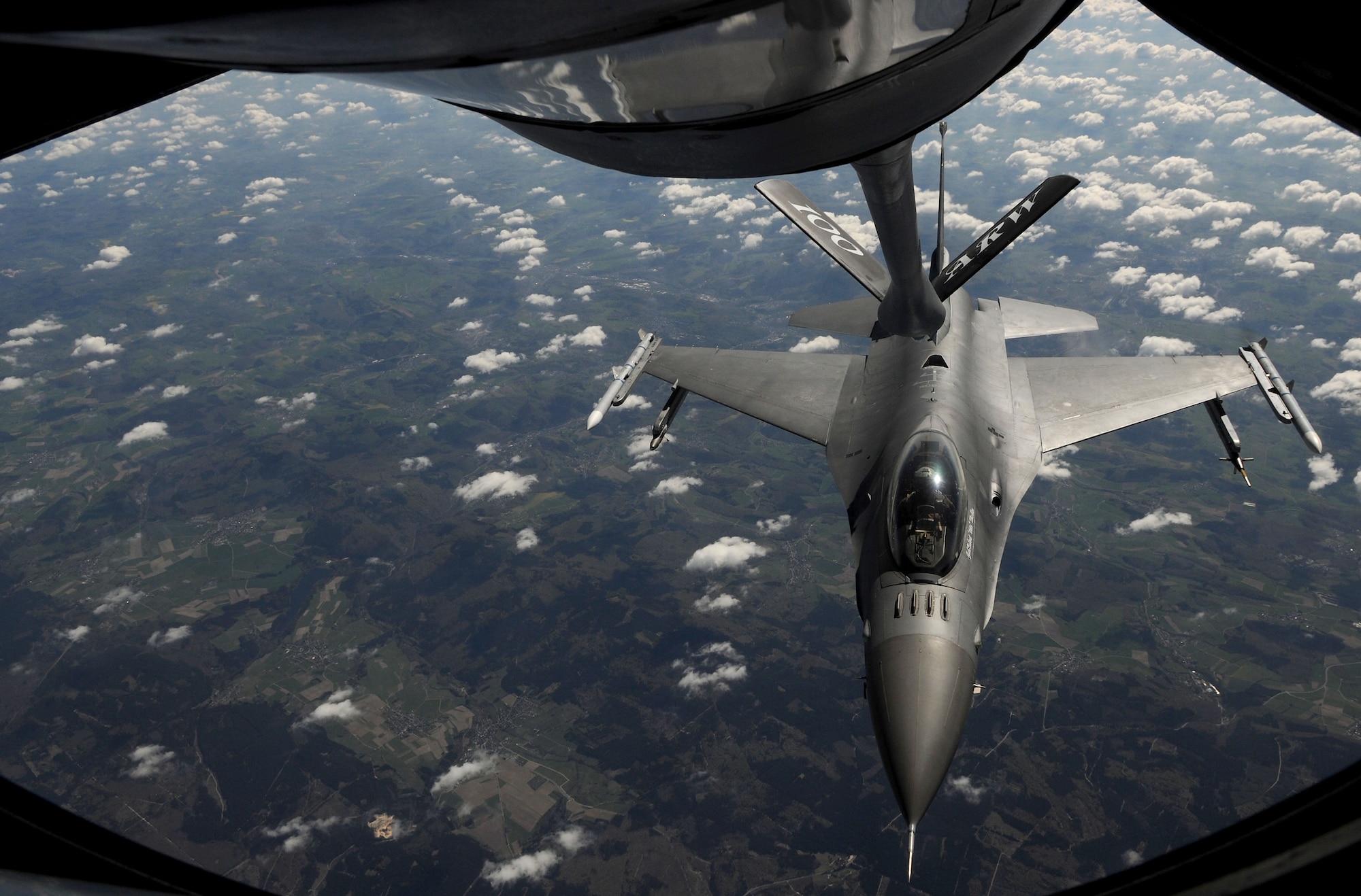 An F-16 Fighting Falcon from Spangdahlem Air Base, Germany, takes on fuel from a KC-135 Stratotanker from RAF Mildenhall, England, April 16, 2014, over Germany. Specialized KC-135s can refuel several types of receivers – even those that burn different types of gas – by using a system that segregates fuel tanks spread throughout the wings and belly of the airframe. (U.S. Air Force photo by Senior Airman Kate Maurer/Released)