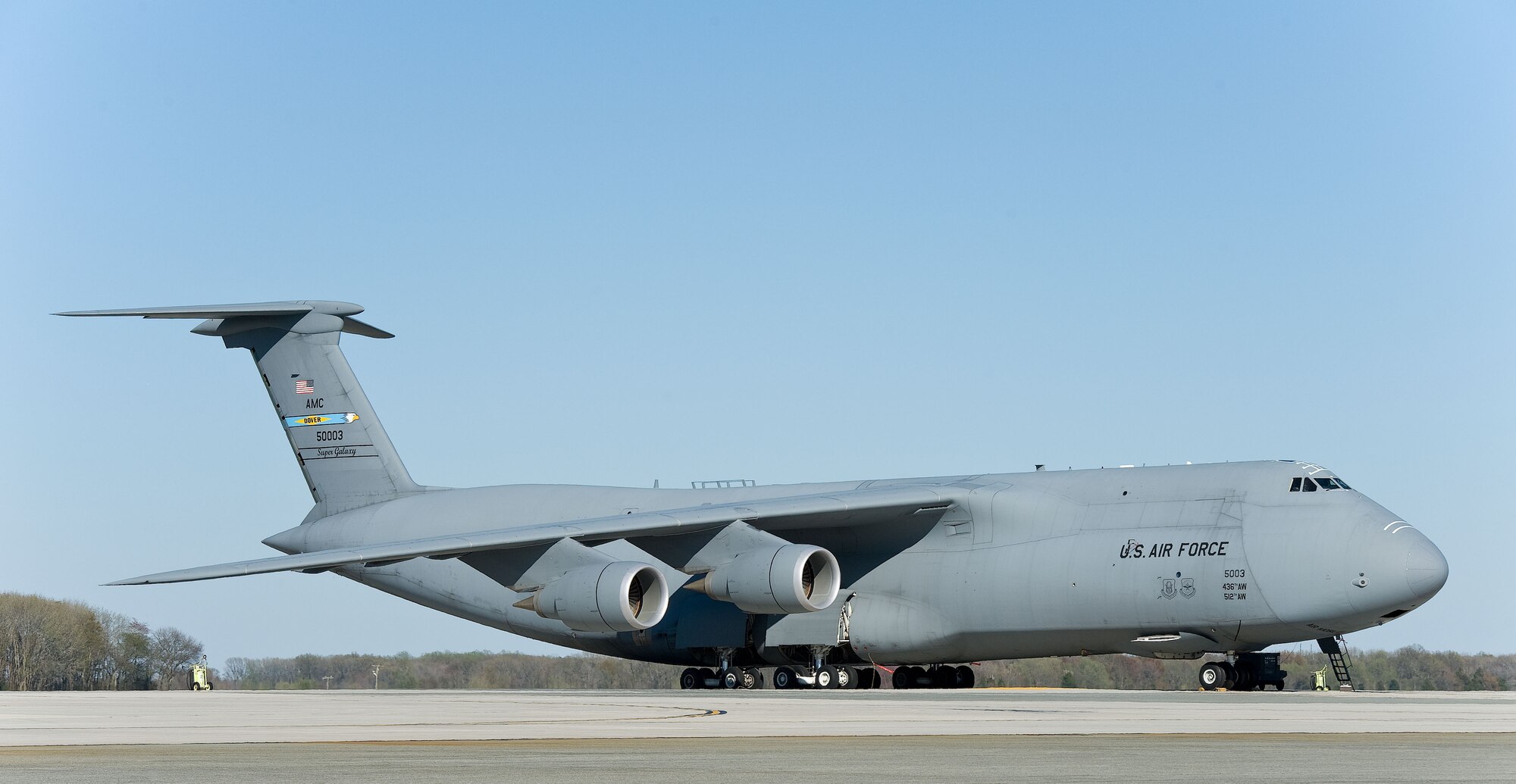 A C-5M Super Galaxy sits on the flight line April 16, 2014, at Dover Air Force Base, Del.  The Super Galaxy features over 70 upgrades, including four General Electric Aviation CF6-80C2 engines, a modernized digital cockpit, communications, enhanced navigation and safety equipment, and an all-weather flight control system. (U.S. Air Force photo/Roland Balik)