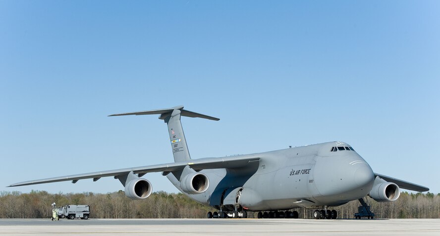 A C-5M Super Galaxy sits on the flight line April 16, 2014, at Dover Air Force Base, Del.  The Super Galaxy features over 70 upgrades, including four General Electric Aviation CF6-80C2 engines, a modernized digital cockpit, communications, enhanced navigation and safety equipment, and an all-weather flight control system. (U.S. Air Force photo/Roland Balik)