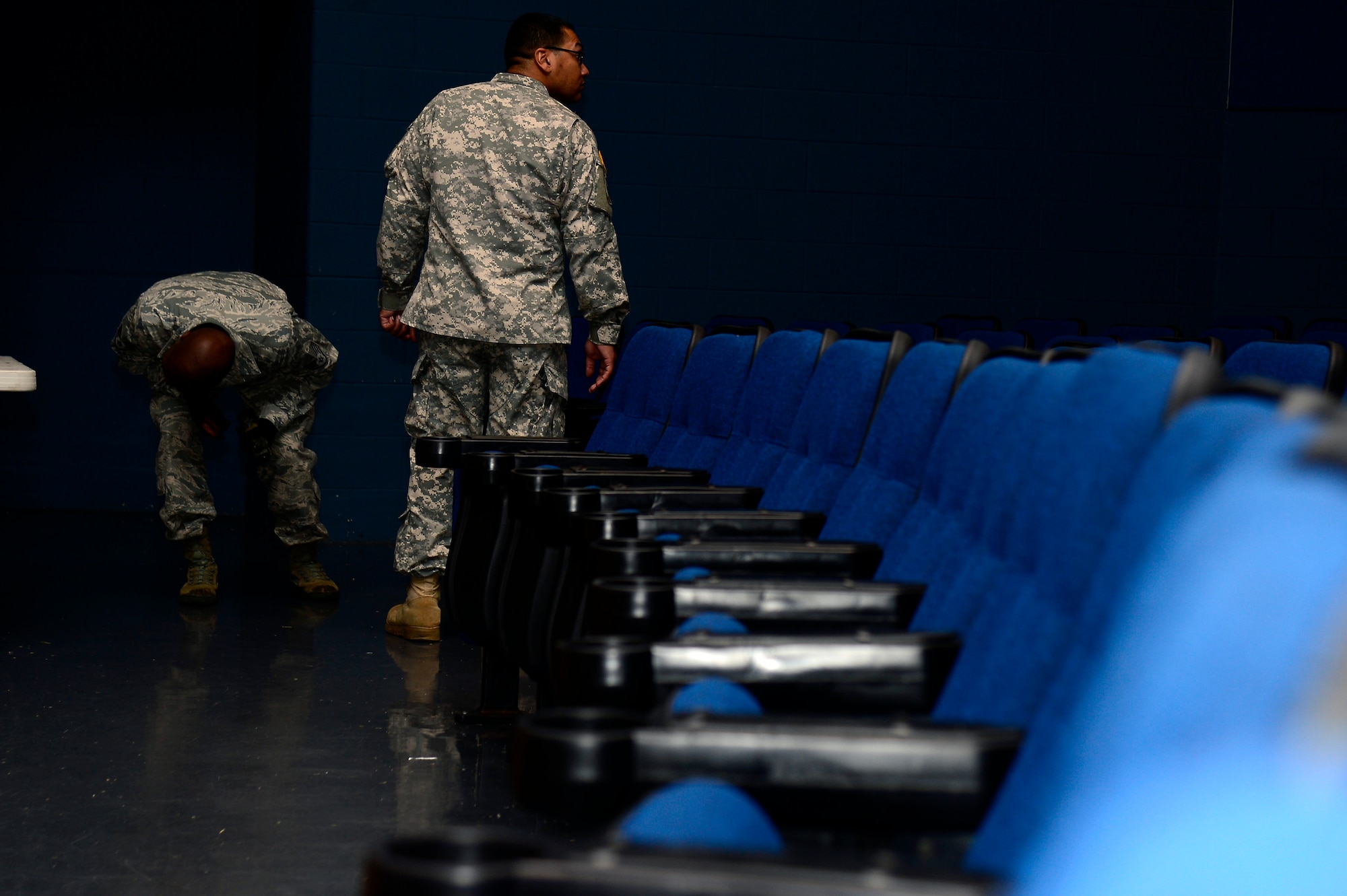 U.S. Army Sgt. Avery Arrington, 221st Military Police Detachment traffic noncommissioned officer in charge, and U.S. Air Force Staff Sgt. Dontarie Russ, 633rd Security Forces Squadron military working dog trainer, set up for explosive detection training at Langley Air Force Base, Va., April 15, 2014. Arrington participated in the Security Forces/Military Police Exchange Program, where one week a month Soldiers and Airmen switch places learn about each other’s job. (U.S. Air Force photo by Senior Airman Kayla Newman/Released)