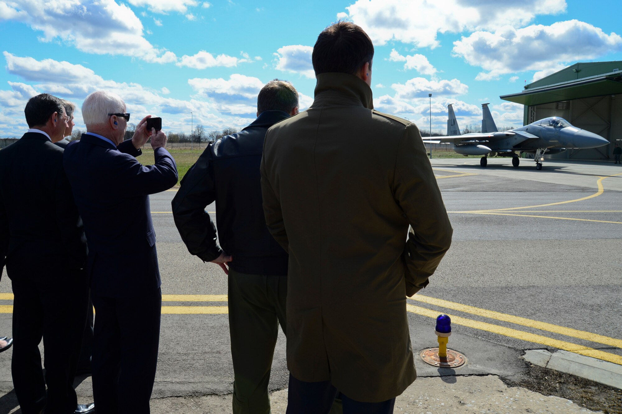 U.S. Senators John McCain, John Hoeven and John Barrasso watch an F-15C Eagle takeoff during a training mission at Šiauliai Air Base, Lithuania, April 16, 2014. The Senators visited the Baltic Air Policing mission as part of a visit to the greater Baltic region, which also includes meetings with government officials in Estonia, Latvia, and Moldova. (U.S. Air Force photo by Airman 1st Class Dana J. Butler/Released)
