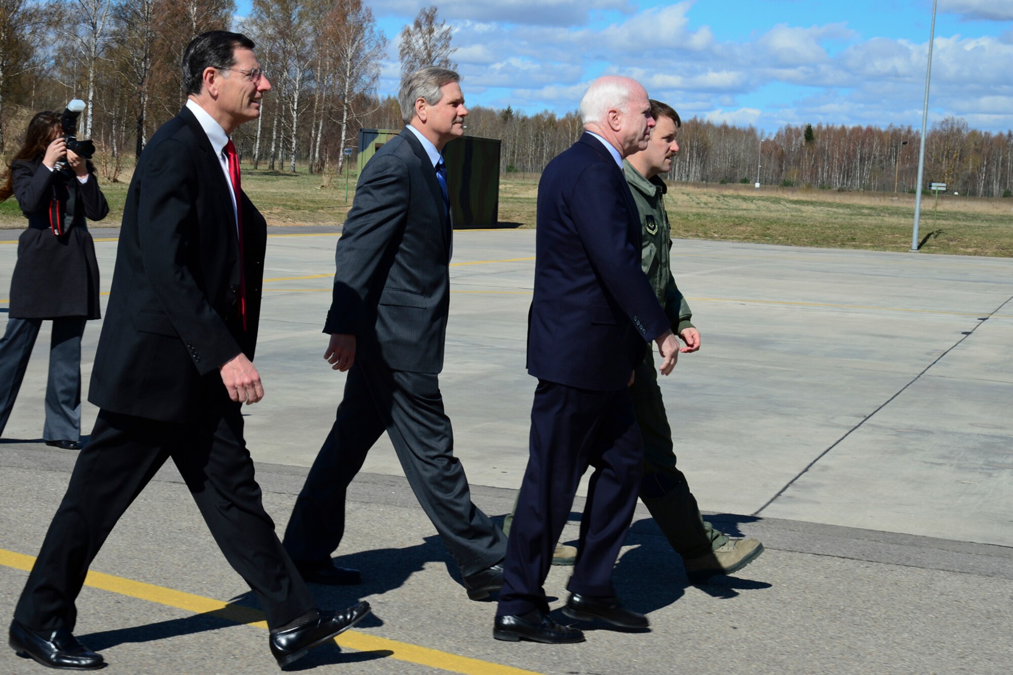 Lt. Col. Lendy Renegar, 48th Air Expeditionary Group commander, escorts U.S. Senators John McCain, John Hoeven and John Barrasso to the flightline at Šiauliai Air Base, Lithuania, April 16, 2014. The Senators visited the Baltic Air Policing mission as part of a visit to the greater Baltic region, which also includes meetings with government officials in Estonia, Latvia, and Moldova. (U.S. Air Force photo by Airman 1st Class Dana J. Butler/Released)