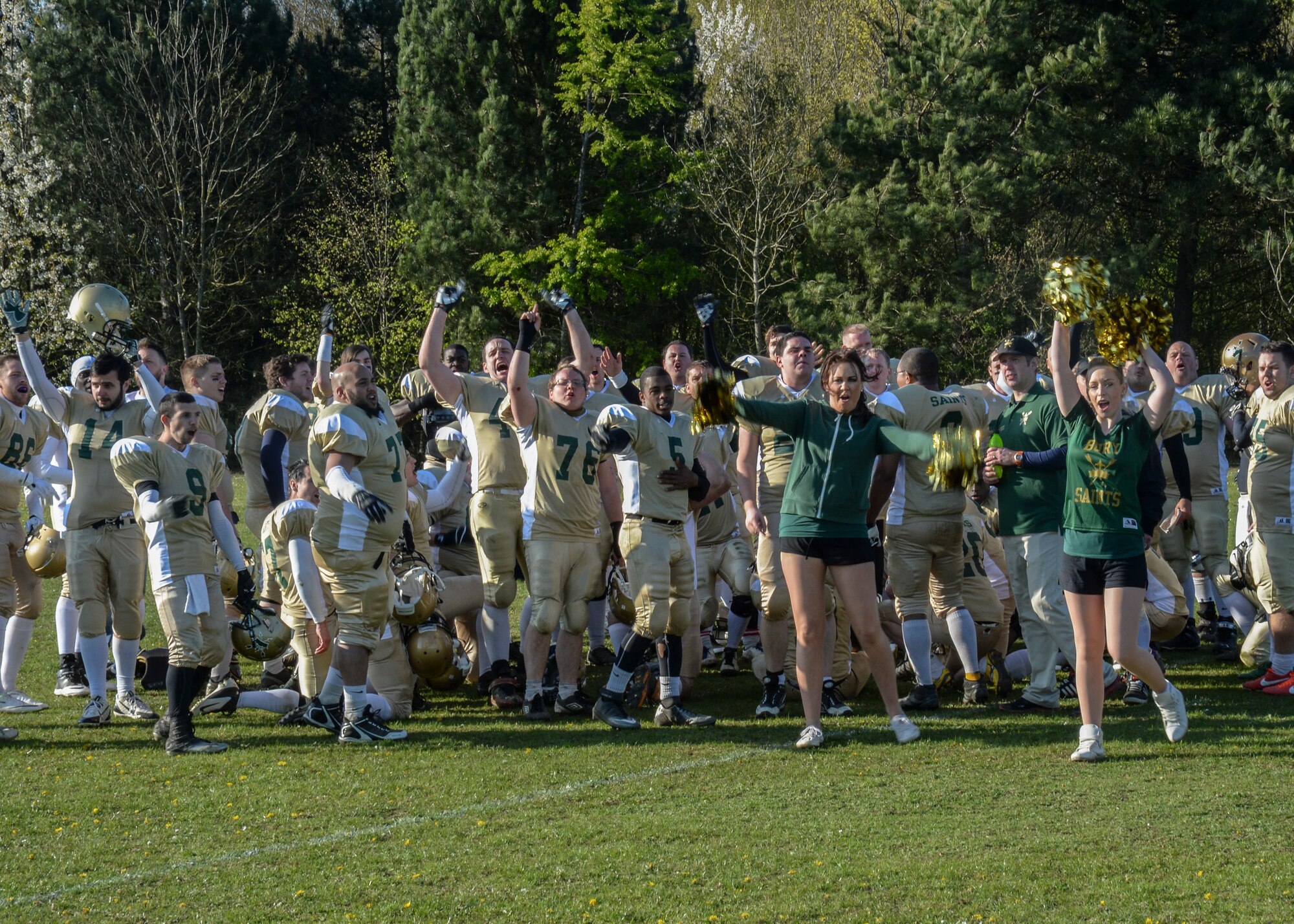 The Bury St. Edmunds Saints celebrate their first-ever 19-13 victory over the Essex Spartans at Thurston Rugby Club in Thurston, England, April 13, 2014. The Saints are an integrated American-style football team comprised of U.S. military members from Royal Air Forces Lakenheath and Mildenhall, along with UK citizens. (U.S. Air Force photo by Airman 1st Class Nigel Sandridge/Released)