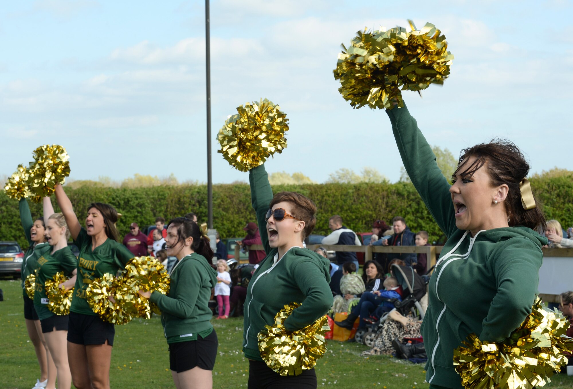 The Bury St. Edmunds Saints cheerleaders fill the area with chants at Thurston Rugby Club in Thurston, England, April 13, 2014. The Saints are an integrated American-style football team comprised of U.S. military members from Royal Air Forces Lakenheath and Mildenhall, along with UK citizens. (U.S. Air Force photo by Airman 1st Class Nigel Sandridge/Released)
