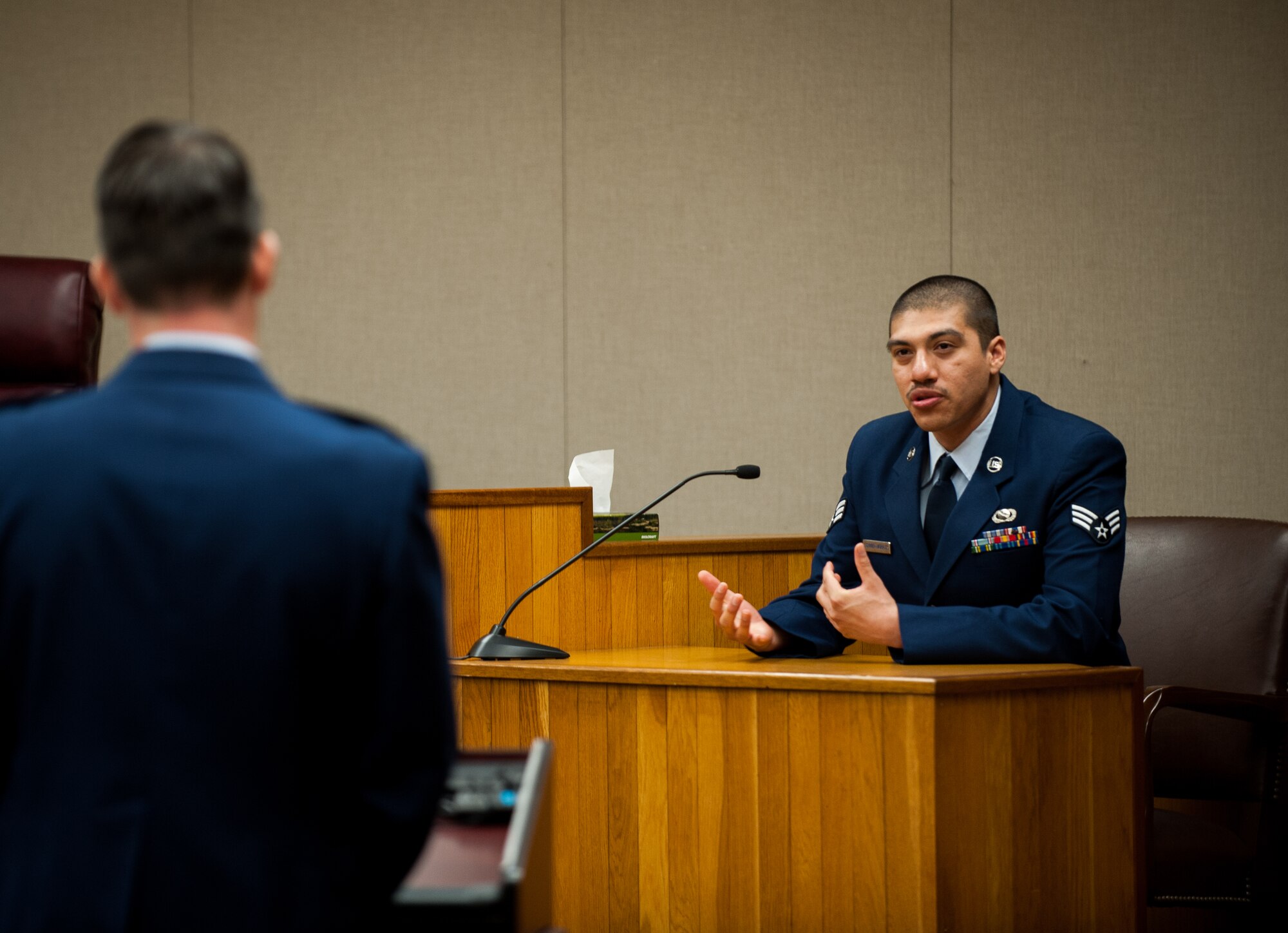 Senior Airman Armando Schwier-Morales, 8th Fighter Wing Public Affairs photojournalist, testifies during a mock trial at Kunsan Air Base, Republic of Korea, April 16, 2014. The Wolf Pack puts on a mock trial of a sexual assault case for First Term Airman Center students to provide a realistic view of the military justice system. (U.S. Air Force photo by Staff Sgt. Clayton Lenhardt/Released)