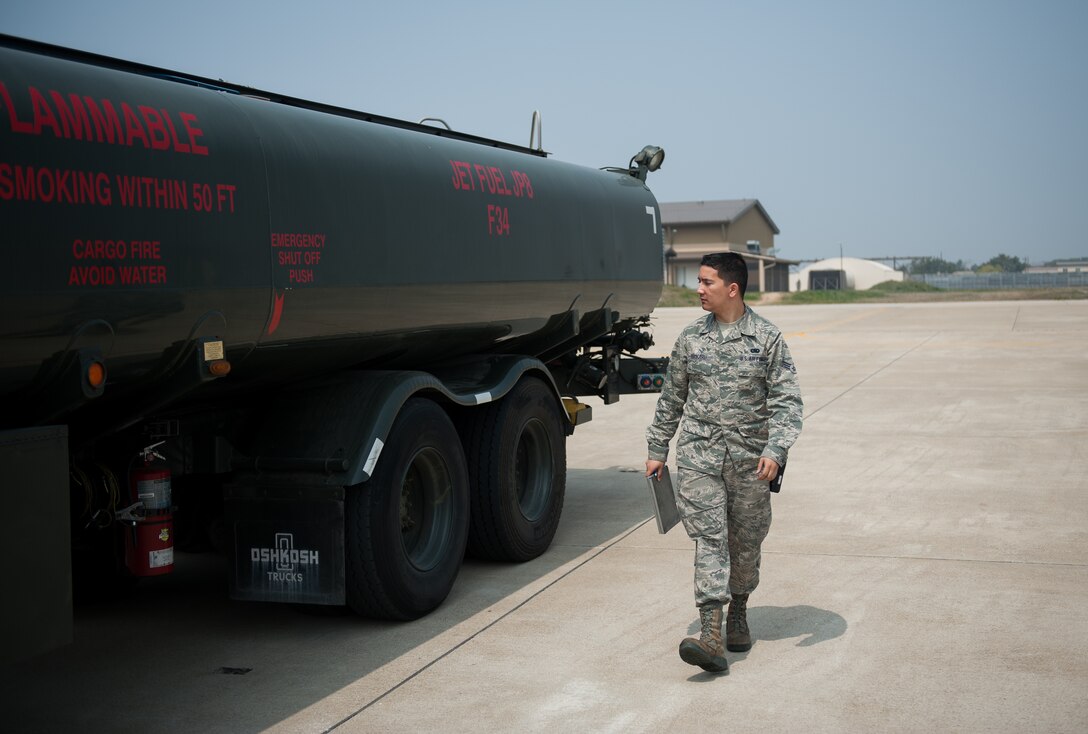 Senior Airman Jacob Rickard, 8th Logistics Readiness Squadron fuels distribution operator, performs a vehicle inspection after refueling an F-16 Fighting Falcon at Kunsan Air Base, Republic of Korea, April 10, 2014. The 8th LRS fuels management flight keeps the Wolf Pack running by delivering fuel when and where it is needed. (U.S. Air Force photo by Staff Sgt. Clayton Lenhardt/Released)