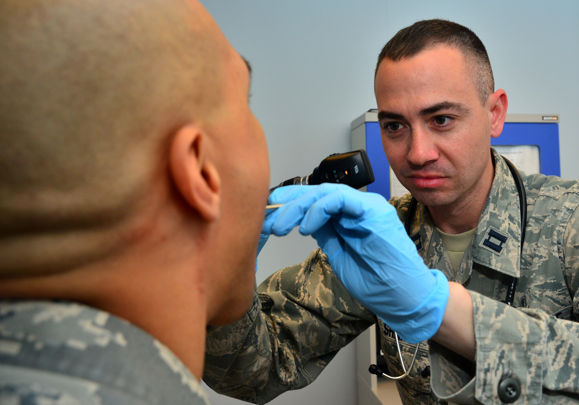 Capt. Michael Shaw, 39th Medical Operations Squadron Personnel Reliability Program clinic, examines the inside of the mouth of a patient April 16, 2014, Incirlik Air Base, Turkey. The PRP clinic reviews records to make sure members are medically ready to accomplish the mission. (U.S. Air Force photo by Staff Sgt. Eric Summers Jr./Released)