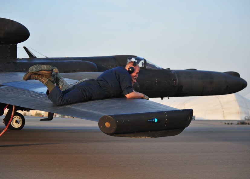 Members of the 380th Expeditionary Aircraft Maintenance Squadron’s Dragon Aircraft Maintenance Unit, ride the wing of a U-2 Dragon Lady after landing to balance the weight of the aircraft as it taxis at an undisclosed location in Southwest Asia, March 24, 2014. (U.S. Air Force photo by Staff Sgt. Michael Means/Released)
