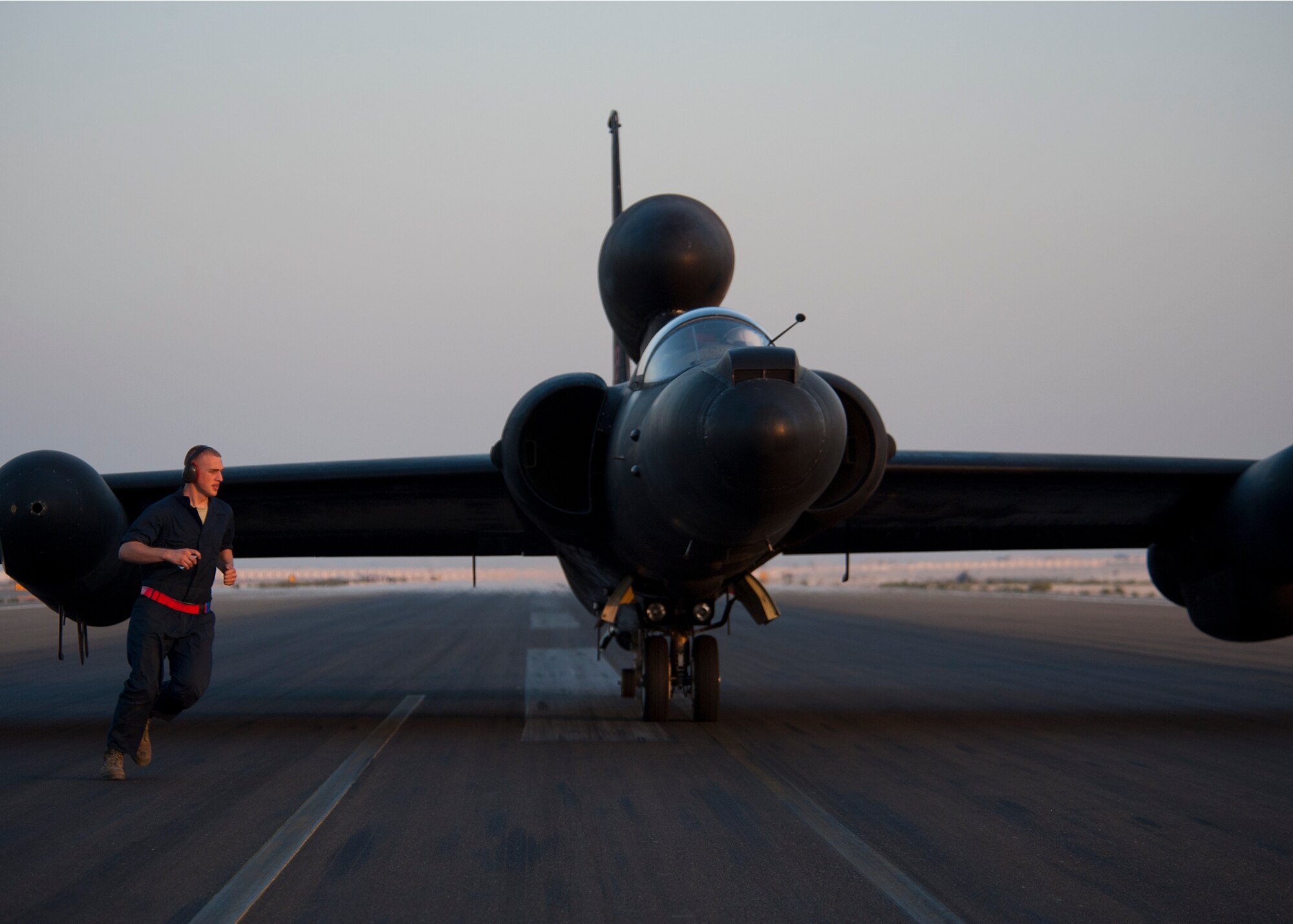 A U.S. Air Force maintainer from the 380th Aircraft Maintenance Squadron’s runs around a U-2 Dragon Lady from the 99th Expeditionary Reconnaissance Squadron after installing a pogo support at an undisclosed location in Southwest Asia, Mar. 6, 2014. The U-2 uses pogo supports under each wing while it is on the ground to improve stability. (U.S. Air Force photo by Staff Sgt. Michael Means/Released)