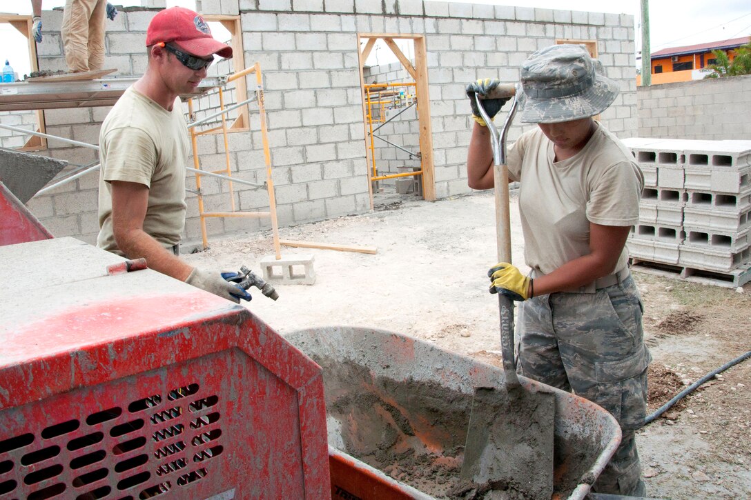 U.S. Air Force Senior Airman Jonathan Barlow, left, and U.S. Air Force Senior Airman Janna Harina mix mortar at the Sadie Vernon Technical High School construction site in Belize City, Belize, April 16, 2014. Barlow is an electrician and Harina is a medical technician.