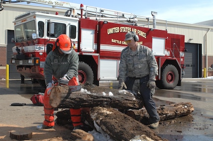 U.S. Air Force Tech. Sgt. Cana Garrison, of Grand Ledge, Mich., and an air transportation journeyman with the 217th Air Operations Group, Battle Creek Air National Guard Base, Mich., practices proper chain saw skills instructed by 217th Air Component Operations Squadron superintendent Chief Master Sgt. Jim Trainor at the base March 14, 2014. Garrison was among 100 volunteers from the 110th Airlift Wing who trained to become members of the Disaster Assistance Response Team. The DART will support civil authorities to safeguard public health and safety, mitigate property and environmental damage, and save lives during manmade or natural disasters.
