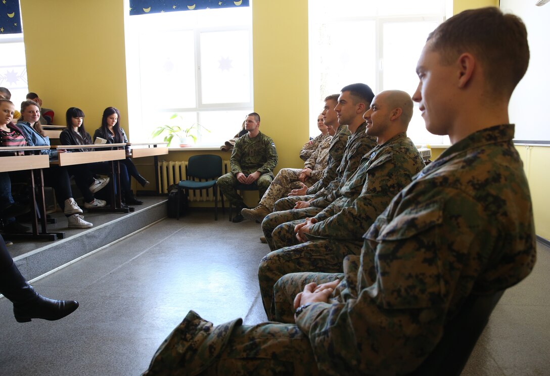 United States Marines, Latvian soldiers and an Estonian service member take questions from a class at Lejasciems Secondary School in Lejasciems, Latvia, April 9, 2014. The service members were invited to the school during Summer Shield to speak with children at the school about their experiences in the military, and to answer any other questions they had. This is the 11th iteration of the Summer Shield exercise, a joint staff planning and combined arms live fire maneuver event designed to enhance the Latvian Land Force’s capacity and capability to integrate fires and maneuver at the battalion and brigade level as well as increase partner capacity, promote regional stability, and continue to develop Latvian, Lithuanian, Estonian and U.S. interoperability. (Official Marine Corps photo by Lance Cpl. Scott W. Whiting, BSRF PAO/ Released)