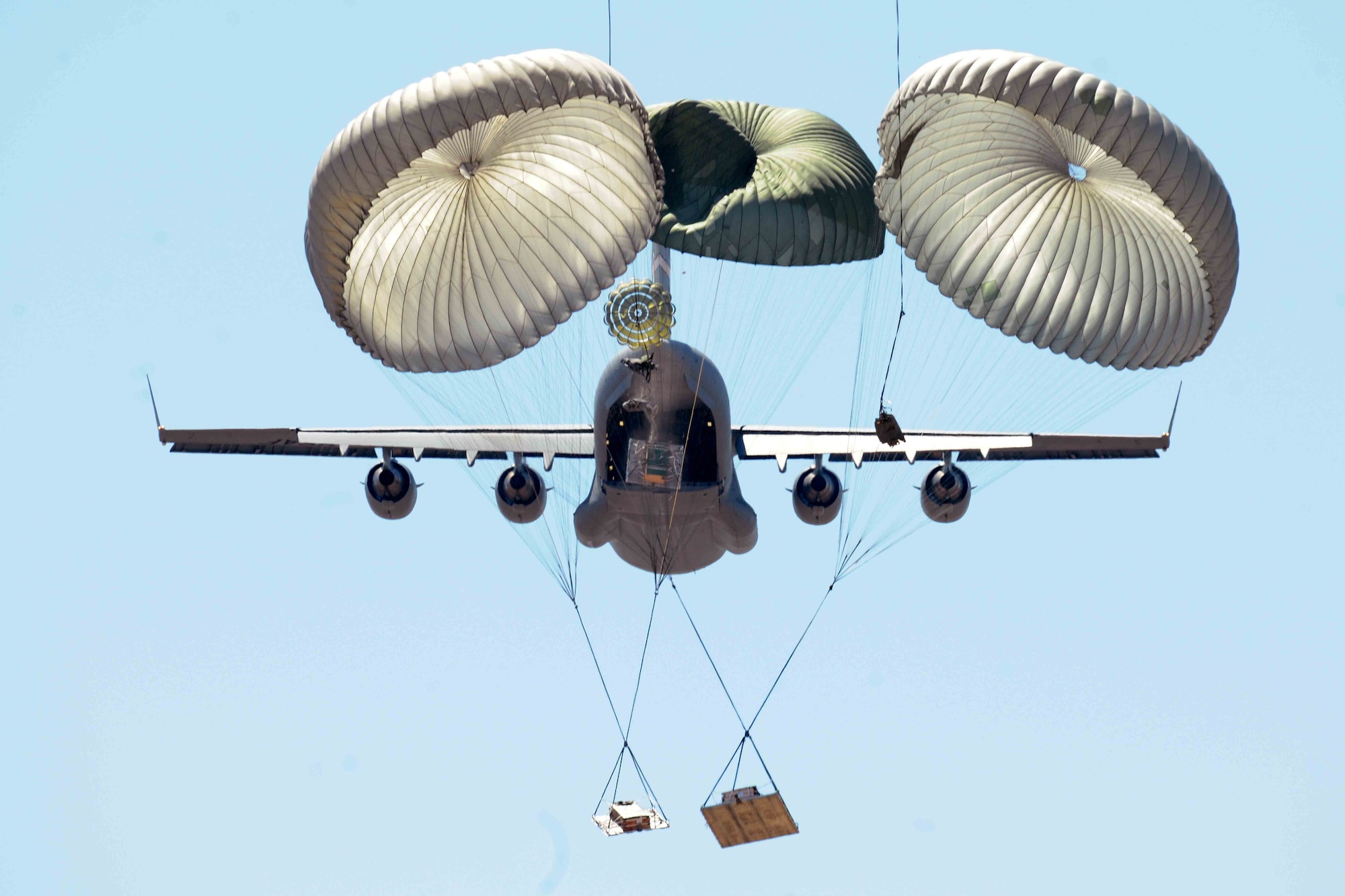 Members of the 58th Airlift Squadron release unilateral airdrop training loads from a C-17 Globemaster III during an airdrop training mission at the Sooner Drop Zone April 11, 2014, near Hollis, Okla. The 97th Aerial Operations Flight prepares airdrop cargo pallets and loads them onto the C-17s. Their mission provides C-17 aircrews with realistic training scenarios, which consist of on and off loading general cargo and vehicles as well as aerial delivery materials for airdrop training. (U.S. Air Force photo/Senior Airman Jesse Lopez)