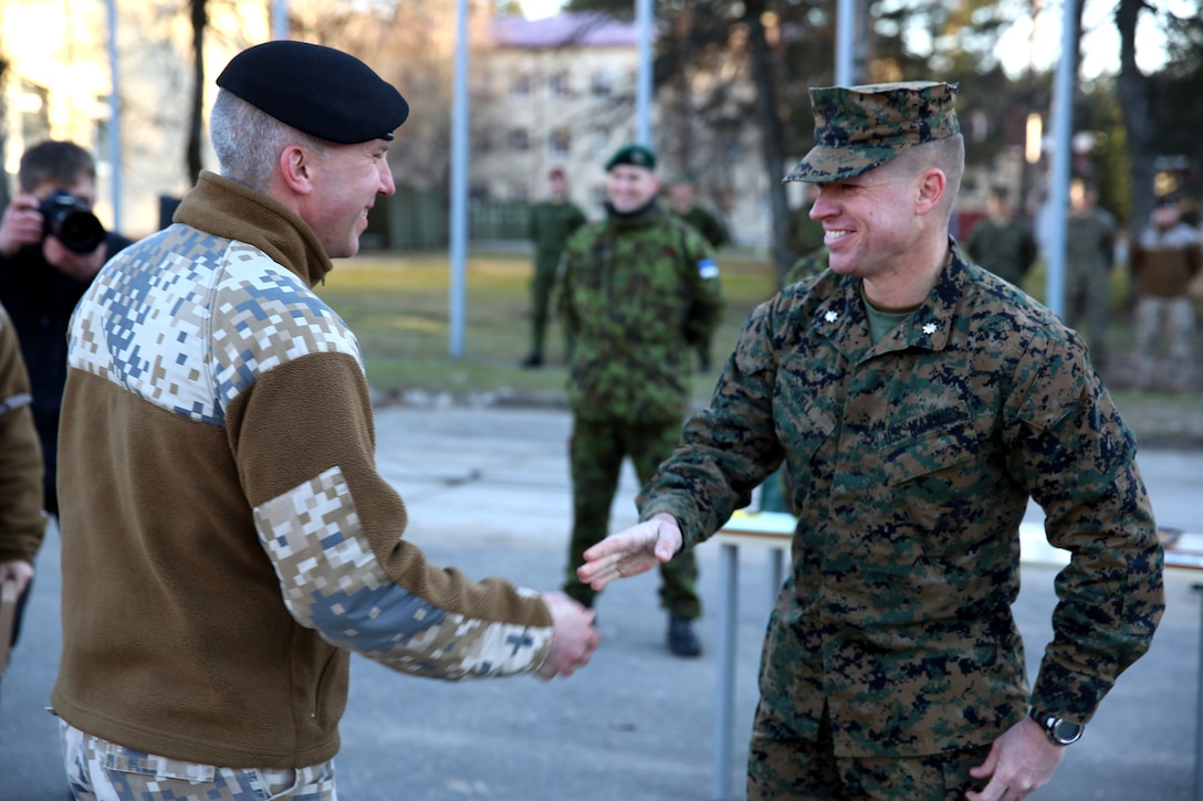 U.S. Marine Lt. Col. Trevor Hall, battalion commander of Black Sea Rotational Force 14 from 3rd Battalion, 8th Marine Regiment, 2nd Marine Division, shakes hands with Latvian Lt. Col. Gunars Kaulins, the exercise director of Summer Shield, during the closing ceremony for Summer Shield aboard Camp Adazi, Latvia, April 16, 2014. This is the 11th iteration of the Summer Shield exercise, a joint staff planning and live-fire maneuver event designed to enhance the NATO force’s capacity and capability to integrate combined arms and maneuver at the battalion and brigade level. It also increases partner capacity, promotes regional stability, and enhances Latvian, Lithuanian, Estonian, and U.S. interoperability as NATO allies. (Official Marine Corps photo by Lance Cpl. Scott W. Whiting, BSRF PAO/ Released)