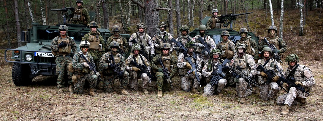 Marines of Black Sea Rotational Force 14 from 3rd Battalion, 8th Marine Regiment, 2nd Marine Division, pose for a picture with Latvian soldiers while training together during exercise Summer Shield at a range near Camp Adazi, Latvia, April 14, 2014. This is the 11th iteration of the Summer Shield exercise, a joint staff planning and combined-arms live fire maneuver event designed to enhance the Latvian Land Force’s capacity and capability to integrate fires and maneuver at the battalion and brigade level. It also increases partner capacity, promotes regional stability, and continues to develop Latvian, Lithuanian, Estonian and U.S. interoperability. (Official Marine Corps photo by Lance Cpl. Scott W. Whiting, BSRF PAO/ Released)