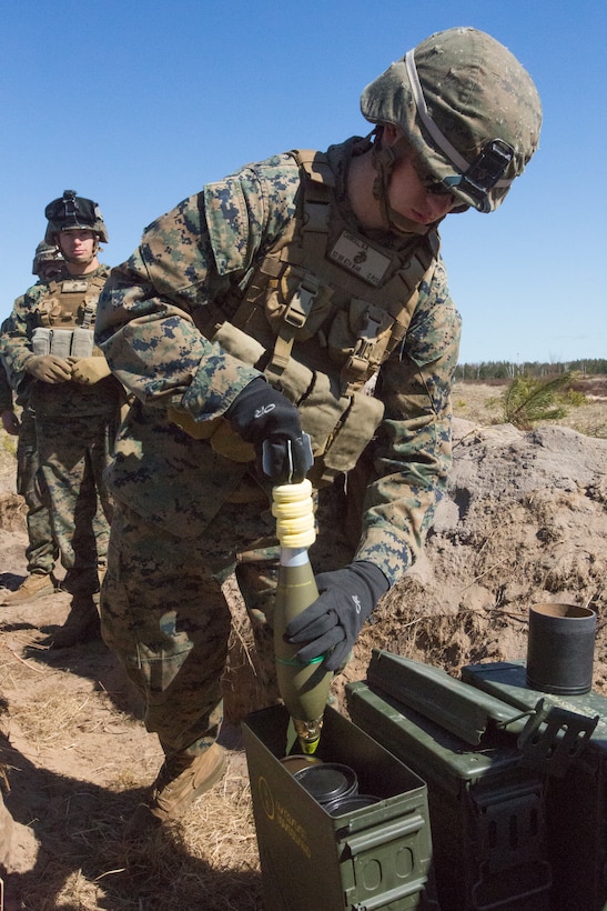 Lance Corporal Michael Carroll, mortarman, assigned to Black Sea Rotational Force 14.2 from Weapons Company, 3rd Battalion, 8th Marine Regiment, pulls and 81mm high explosive round out of an ammo can during Summer Shield, April 16, 2014, Camp Adazi, Latvia. The Marines in the live fire were a fire-support team element and worked with the Latvian Land Forces in order to synchronize an integrated attack that would use fire-support elements from three different countries.  This is the 11th iteration of the Summer Shield exercise, a joint, staff planning and combined-arms live fire maneuver event designed to enhance the Latvian Land Force’s capacity and capability to integrate fires and maneuver at the battalion and brigade level as well as increase partner capacity, promote regional stability and continue to develop Latvian, Lithuanian, Estonian and U.S. interoperability.  (Official Marine Corps photo by Staff Sgt. Tanner M. Iskra, 2nd Marine Division Combat Camera, BSRF-14/Released)