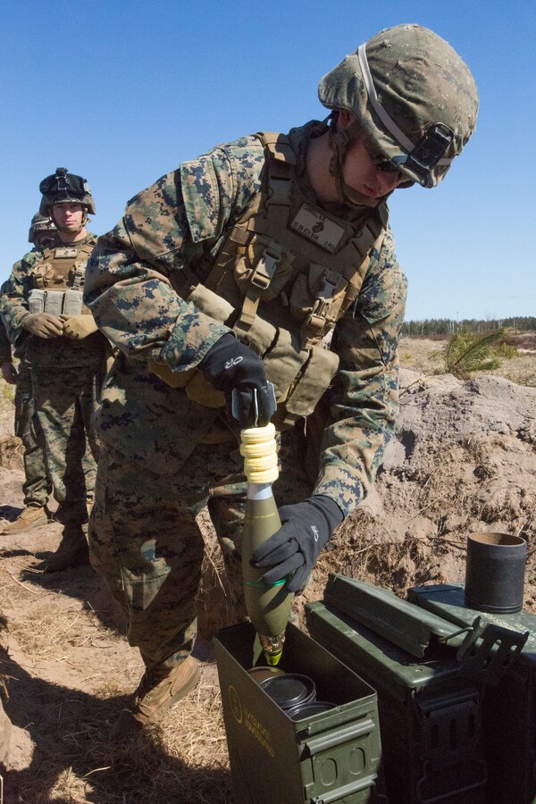 Lance Corporal Michael Carroll, mortarman, assigned to Black Sea Rotational Force 14.2 from Weapons Company, 3rd Battalion, 8th Marine Regiment, pulls and 81mm high explosive round out of an ammo can during Summer Shield, April 16, 2014, Camp Adazi, Latvia. The Marines in the live fire were a fire-support team element and worked with the Latvian Land Forces in order to synchronize an integrated attack that would use fire-support elements from three different countries.  This is the 11th iteration of the Summer Shield exercise, a joint, staff planning and combined-arms live fire maneuver event designed to enhance the Latvian Land Force’s capacity and capability to integrate fires and maneuver at the battalion and brigade level as well as increase partner capacity, promote regional stability and continue to develop Latvian, Lithuanian, Estonian and U.S. interoperability.  (Official Marine Corps photo by Staff Sgt. Tanner M. Iskra, 2nd Marine Division Combat Camera, BSRF-14/Released)
