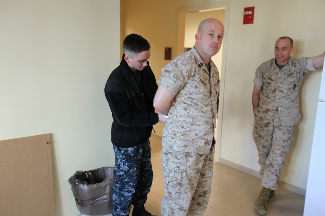 Master Gunnery Sgt. Bradley Everett, the operations chief for Special-Purpose Marine Air-Ground Task Force Africa 14, is "arrested" during a jail and bail fundraiser here to support the Navy-Marine Corps Relief Society, March 12, 2014. Marines and sailors donated money to have a coworker arrested and temporarily “jailed.” The Navy-Marine Corps Relief Society provides interest-free loans and other financial services to active duty and retired Navy and Marine Corps personnel and families.