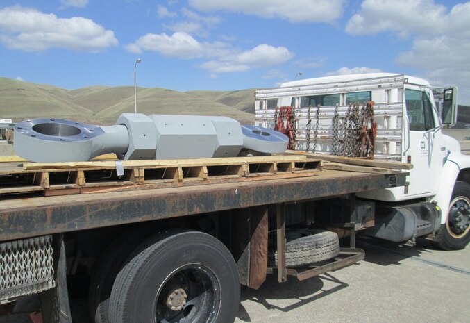 The freshly painted, new gudgeon arm assembly is positioned along the navigation lock on April 15 for installation.