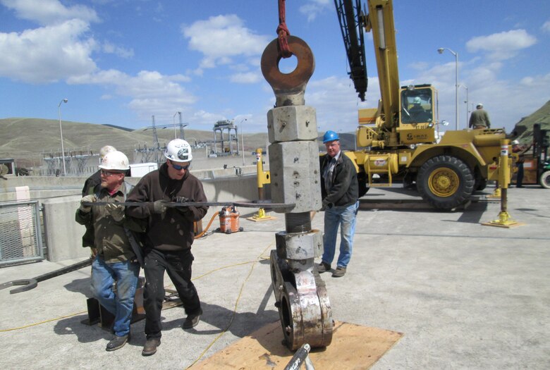 Contractor workers take apart the old, cracked gudgeon arm assembly. The pieces were sent to a metallurgy laboratory for a failure analysis.