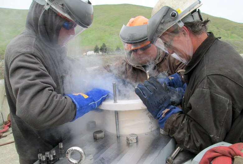 Contractor workers used liquid nitrogen to shrink the new, bronze bushing, allowing it to fit into the new navigation lock gate gudgeon arm assembly.