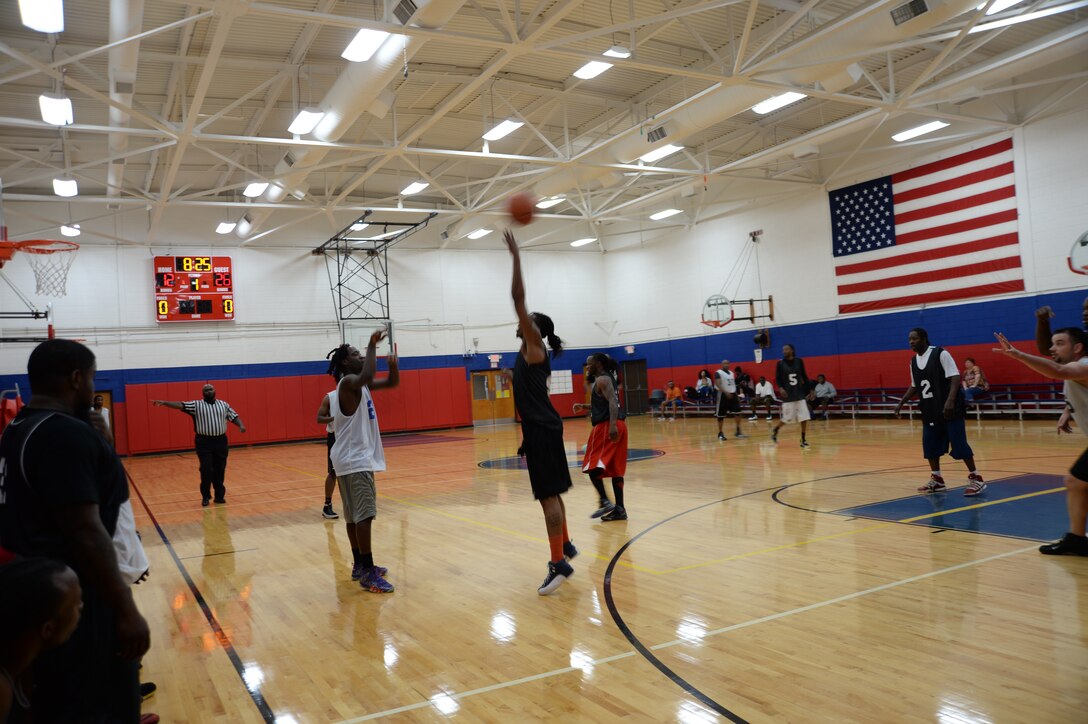 A DoCo Crusaders' player (right) attempts to block a pass to a Base team's player in their play-off matchup at Marine Corps Logistics Base Albany's Thomason Gym, April 10.