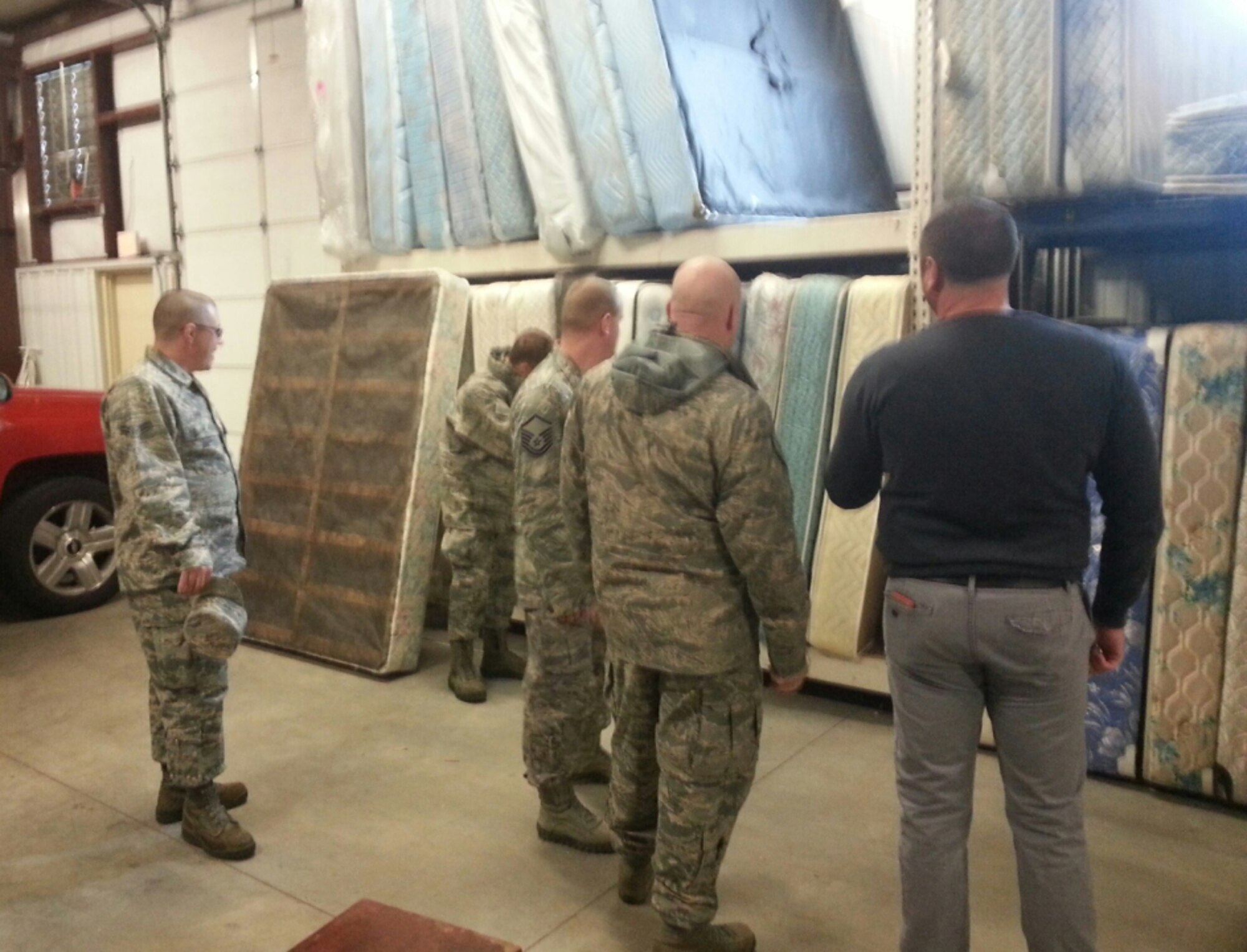 Airmen from McConnell Air Force Base select a mattress and box spring at His Helping Hands, a local non-profit that distributes household items to families in need. The VA in Wichita works with His Helping Hands to provide household goods for homeless veterans as part of their initiative to end homelessness.(Photo courtesy of Johnny Stephenson)