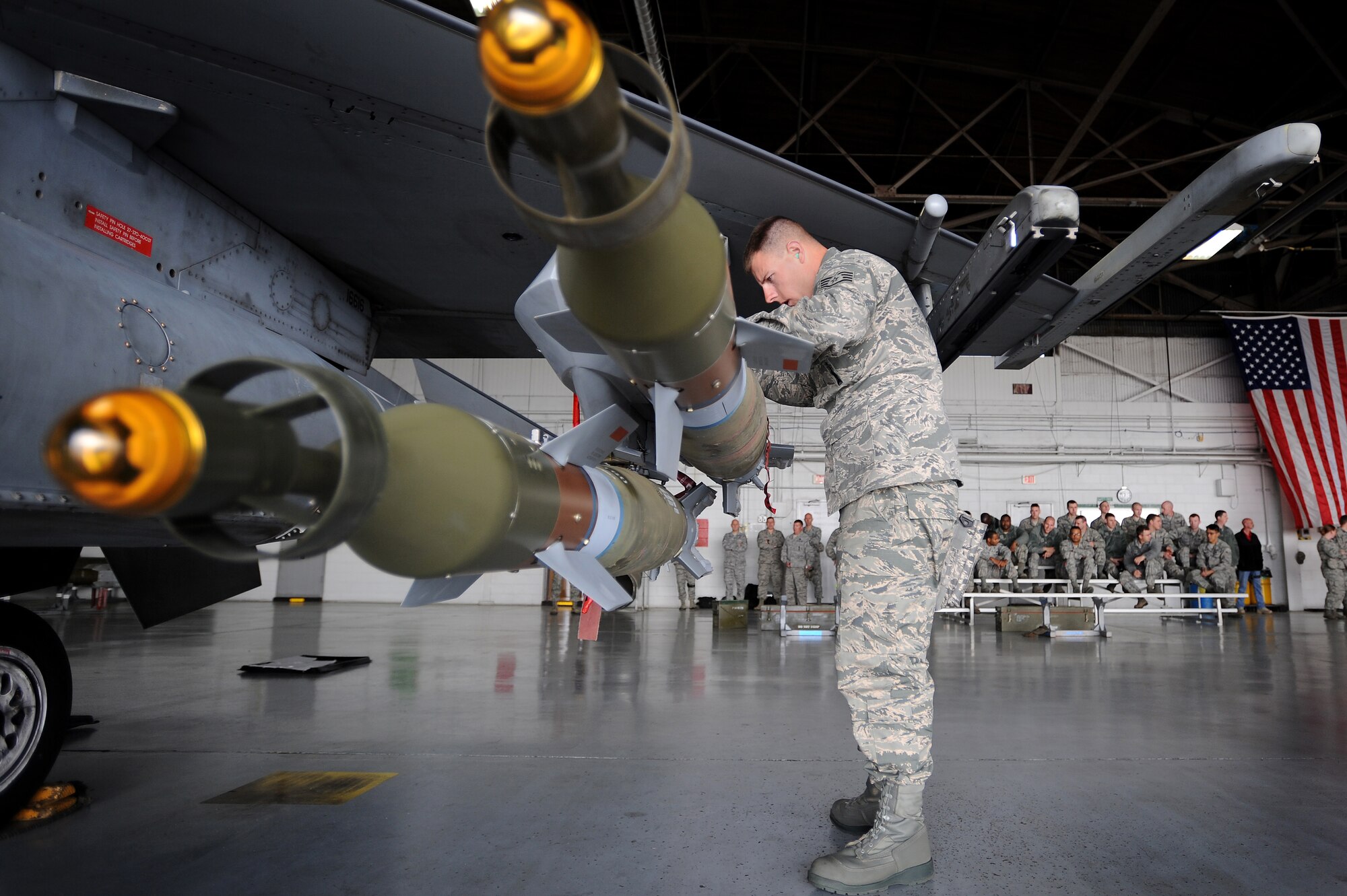 U.S. Air Force Staff Sgt. Randy Therriault, 20th Maintenance Group weapons load crew member, inspects munitions that where rapidly loaded onto an F-16CJ Fighting Falcon by him and his team during a load crew of the year competition, April 18, 2014, Shaw Air Force Base, S.C. The 20th Fighter Wing weapons standardization unit held the annual competition which brings together weapons load crew members from all three fighter squadrons at Shaw to compete against each other. The competition showcases Airmen’s skills and job knowledge while also building camaraderie amongst the units. (U.S. Air Force photo by Staff Sgt. Kenny Holston/Released)