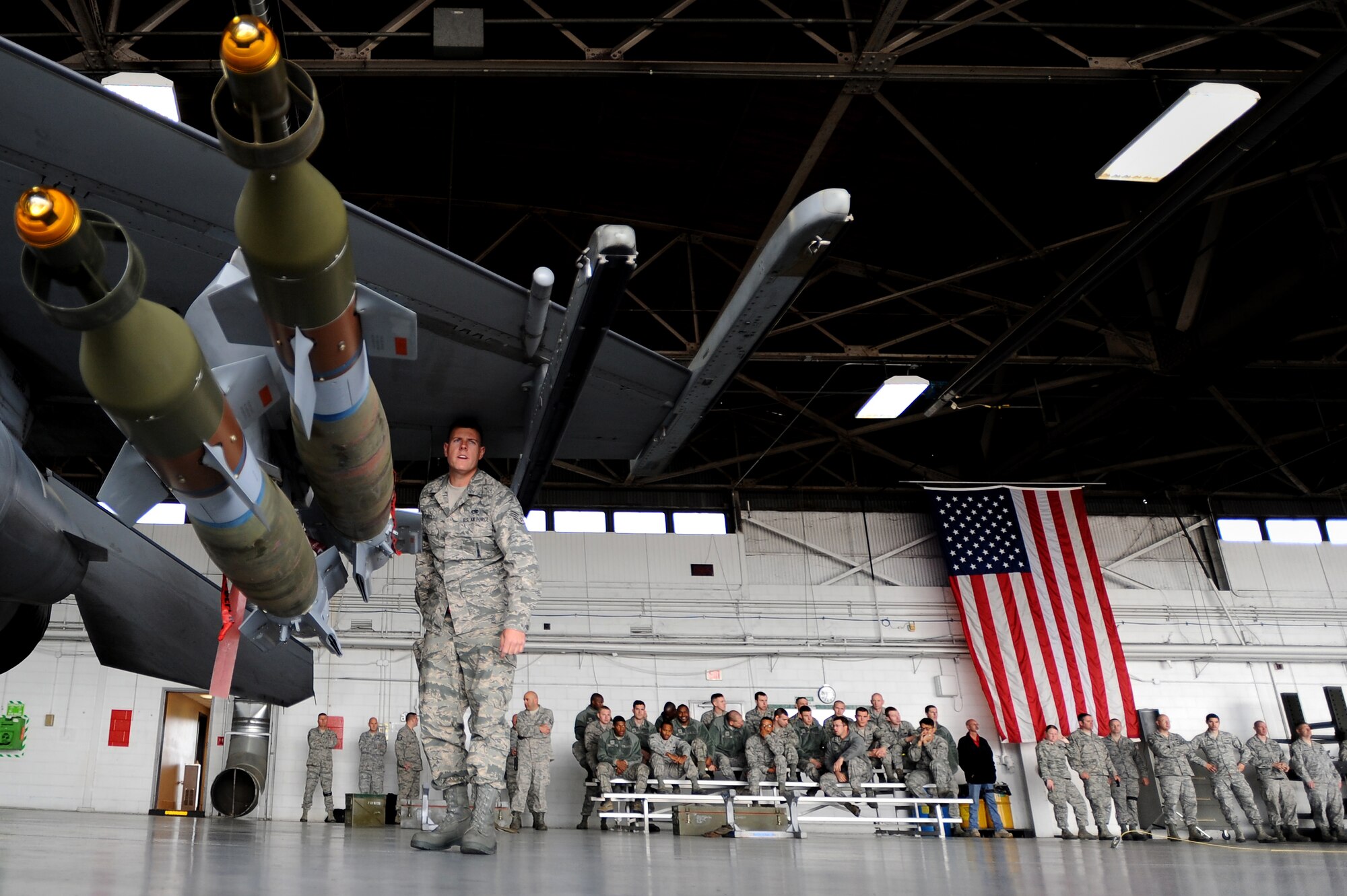 U.S. Air Force Staff Sgt. Randy Therriault, 20th Maintenance Group weapons load crew member, communicates with other load crew members during a load crew of the year competition, April 18, 2014, Shaw Air Force Base, S.C. The 20th Fighter Wing weapons standardization unit held the annual competition which brings together weapons load crew members from all three fighter squadrons at Shaw to compete against each other. The competition showcases Airmen’s skills and job knowledge while also building camaraderie amongst the units. (U.S. Air Force photo by Staff Sgt. Kenny Holston/Released)