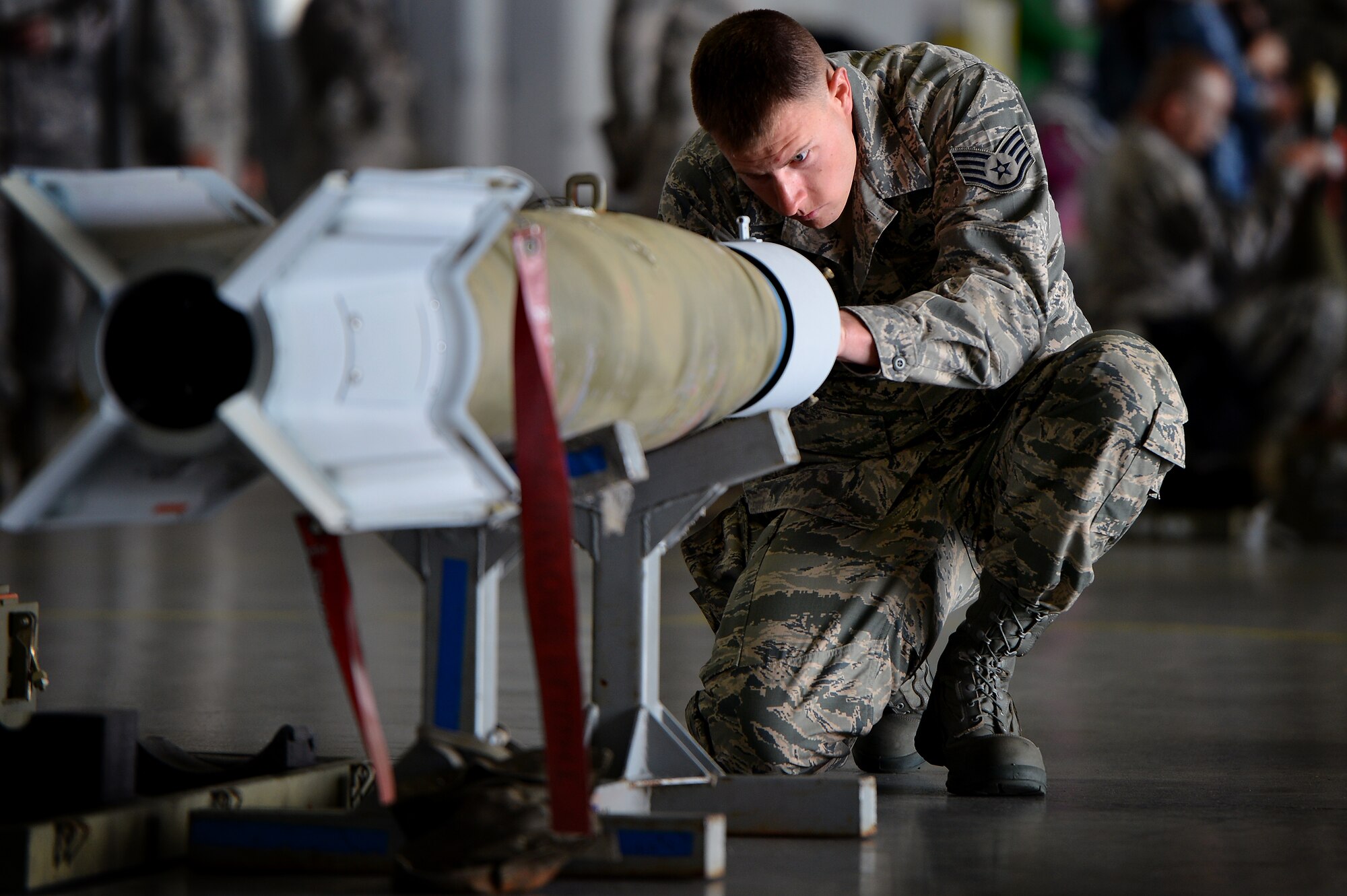 U.S. Air Force Staff Sgt. Randy Therriault, 20th Maintenance Group weapons load crew member, inspects munitions as he and his crew members prepare to load the munitions onto an F-16CJ Fighting Falcon during a load crew of the year competition, April 18, 2014, at Shaw Air Force Base, S.C. The 20th Fighter Wing weapons standardization unit held the annual competition which brings together weapons load crew members from all three fighter squadrons at Shaw to compete against each other. The competition showcases Airmen’s skills and job knowledge while also building camaraderie amongst the units. (U.S. Air Force photo by Staff Sgt. Kenny Holston/Released)