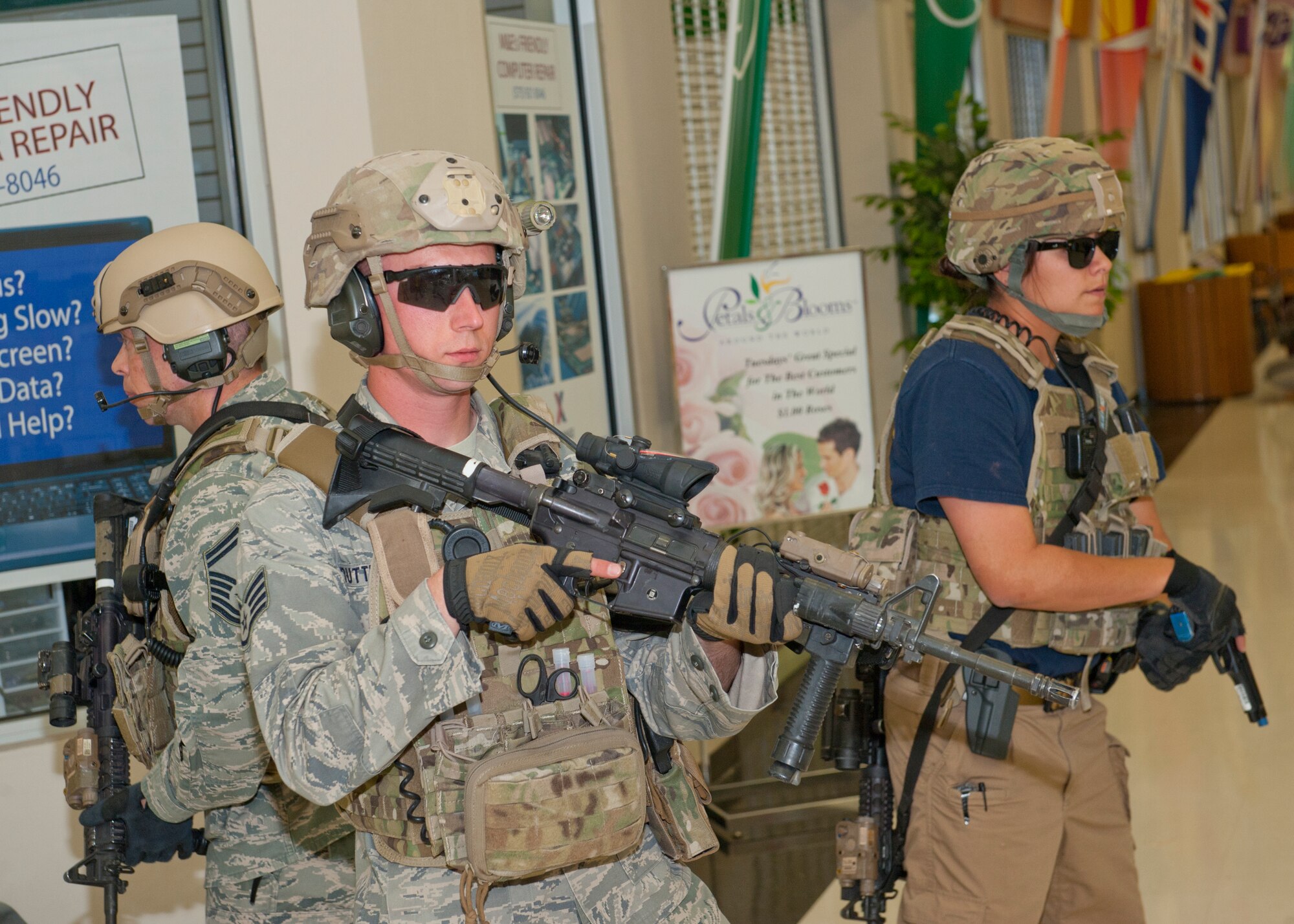 49th Security Forces Squadron special reaction force team members respond to the active shooter exercise as additional support inside the Base Exchange at Holloman Air Force Base, N.M., April 17. Holloman maintains readiness to respond and cope with emergencies such as active shooters by participating in exercises multiple times a year.  The 49th SFS and the 49th Civil Engineer Squadron were able to quickly respond to the exercise scenario, neutralize the threats and evacuate the victims. (U.S. Air Force photo by Senior Airman Daniel Liddicoet/Released)