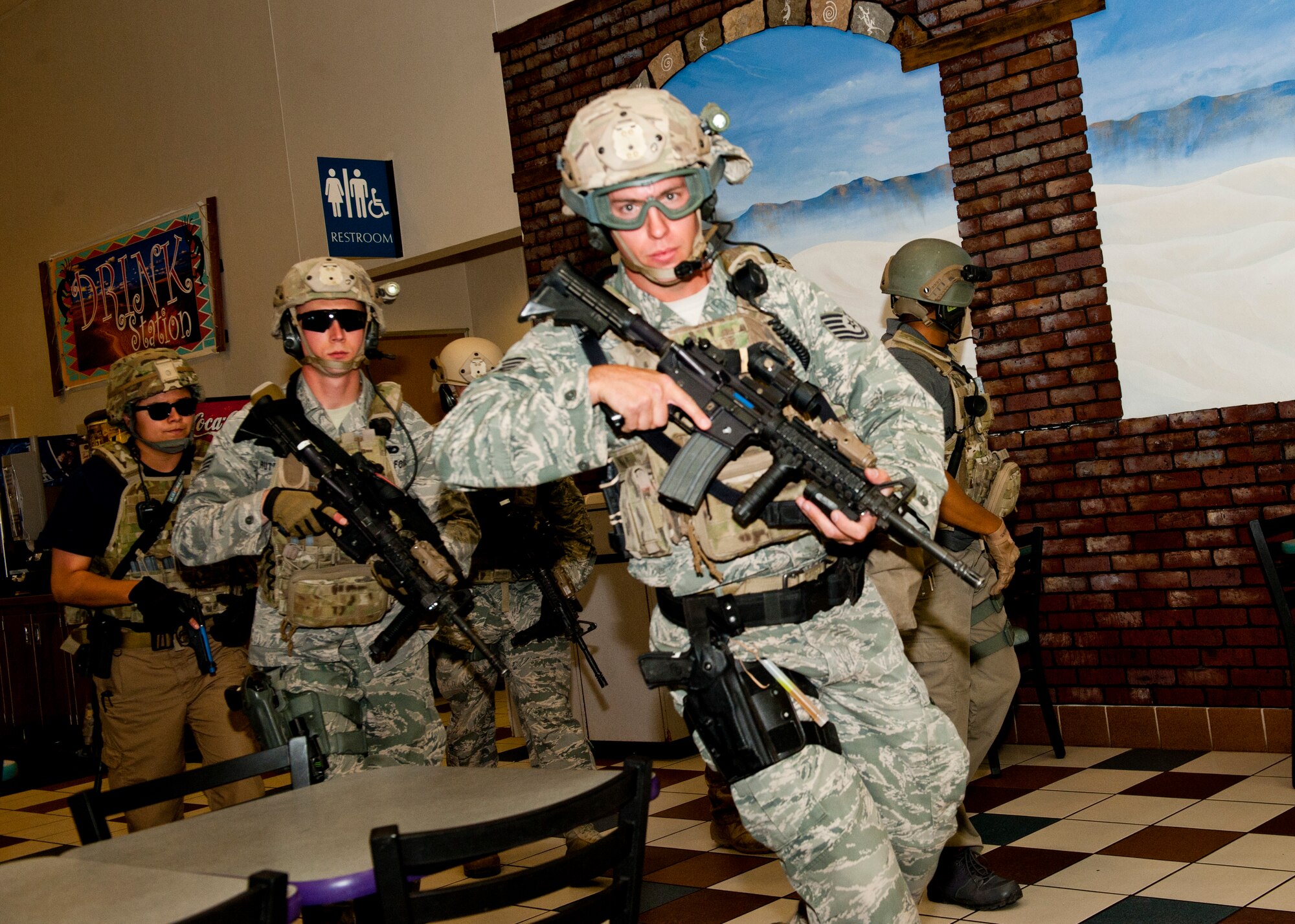 49th Security Forces Squadron special reaction force team members respond to the active shooter exercise as additional support inside the Base Exchange at Holloman Air Force Base, N.M., April 17. Holloman maintains readiness to respond to emergencies such as active shooters by conducting training exercises multiple times a year.  The 49th SFS and the 49th Civil Engineer Squadron were able to quickly respond to the exercise scenario, neutralize the threats and evacuate the victims. (U.S. Air Force photo by Senior Airman Daniel Liddicoet/Released)
