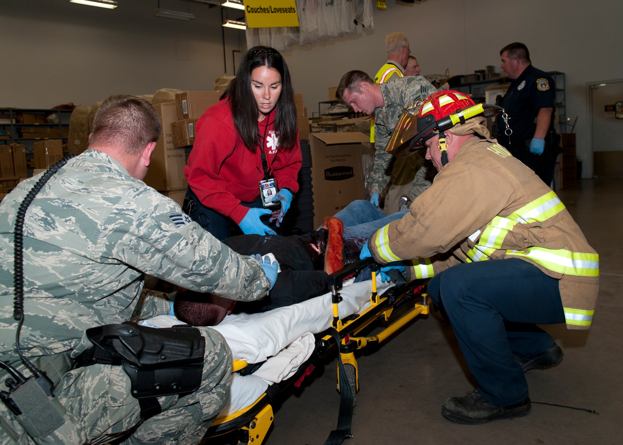 49th Civil Engineer Squadron fire protection flight members along with 49th Security Forces squadron members help evacuate a victim during the active shooter exercise inside the Base Exchange at Holloman Air Force Base, N.M., April 17. Holloman maintains readiness to respond to emergencies such as active shooters by conducting training exercises multiple times a year.  The 49th SFS  and the 49th Civil Engineer Squadron were able to quickly respond to the exercise scenario, neutralize the threats and evacuate the victims. (U.S. Air Force photo by Senior Airman Daniel Liddicoet/Released)