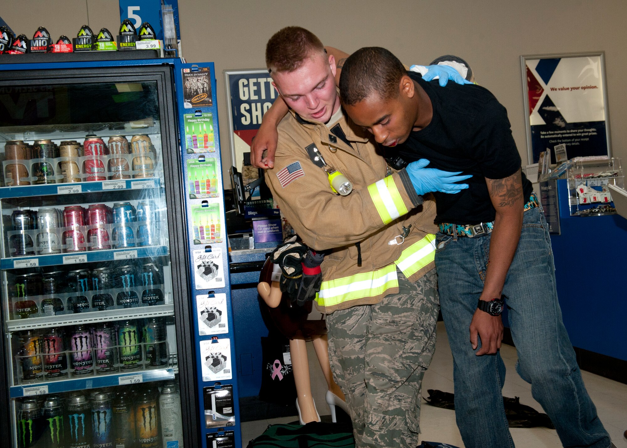 A 49th Civil Engineer Squadron fire protection flight member helps evacuate a victim during the active shooter exercise inside the Base Exchange at Holloman Air Force Base, N.M., April 17. Holloman maintains readiness to respond to emergencies such as active shooters by conducting training exercises multiple times a year.  The 49th Security Forces Squadron and the 49th Civil Engineer Squadron were able to quickly respond to the exercise scenario, neutralize the threats and evacuate the victims. (U.S. Air Force photo by Senior Airman Daniel Liddicoet/Released)