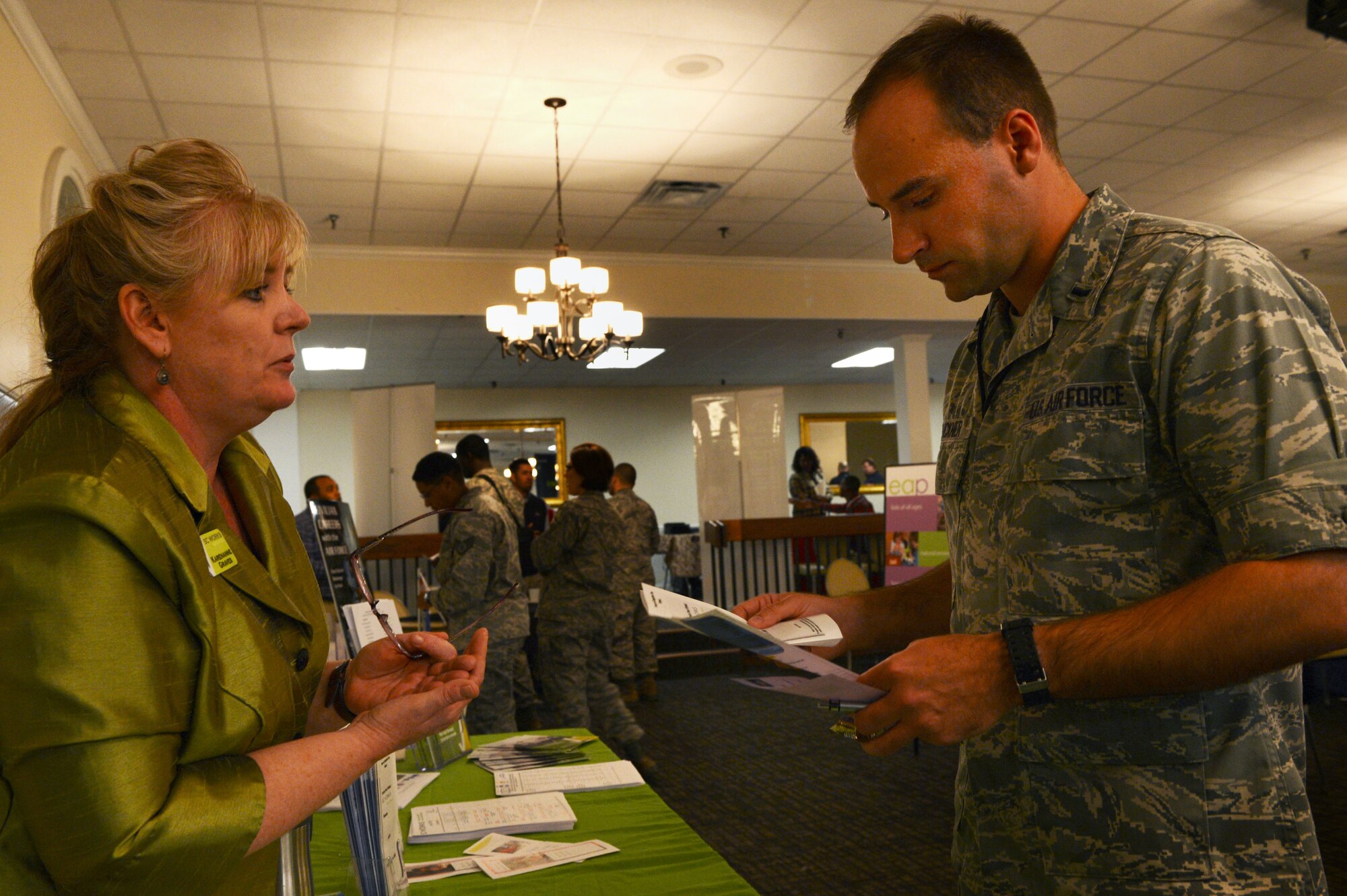 U.S. Air Force 1st Lt. Kyle Bruckner, 55th Fighter Squadron chief of intelligence speaks with a South Carolina Works representative during a job fair at the Carolina Skies Club Shaw Air Force Base, S.C., April 17, 2014. More than 200 Airmen and their spouses learned about potential career opportunities from approximately 50 business representatives. (U.S. Air Force photo by Airman 1st Class Jensen Stidham/Released)