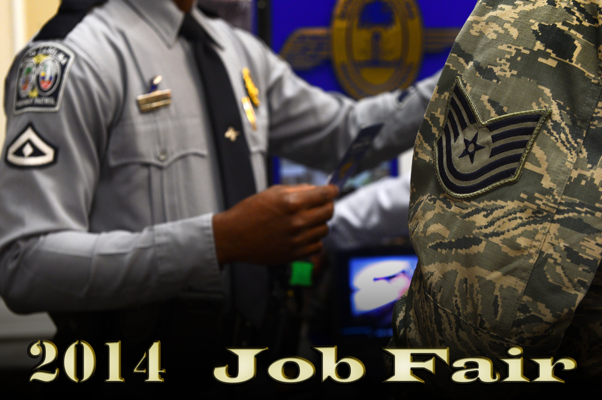A U.S. Air Force Technical Sergeant learns about becoming a South Carolina Highway Patrolman during a job fair at the Carolina Skies Club Shaw Air Force Base, S.C., April 17, 2014. More than 200 Airmen and spouses learned about potential career opportunities from approximately 50 business representatives. (U.S. Air Force photo illustration by Airman 1st Class Jensen Stidham/Released)