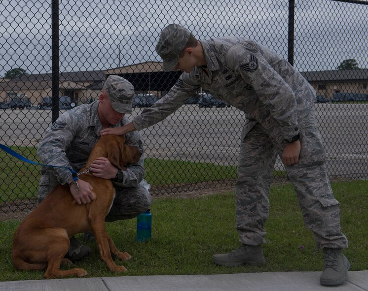 U.S. Air Force Staff Sgt. Colt Crowe, 824th Base Defense Squadron fire team member, hugs his dog at Moody Air Force Base, Ga., April 17, 2014. 824th BDS provides fully-integrated, highly capable and responsive forces to protect Expeditionary Air Forces. (U.S. Air Force photo by Airman Dillian Bamman/Released)