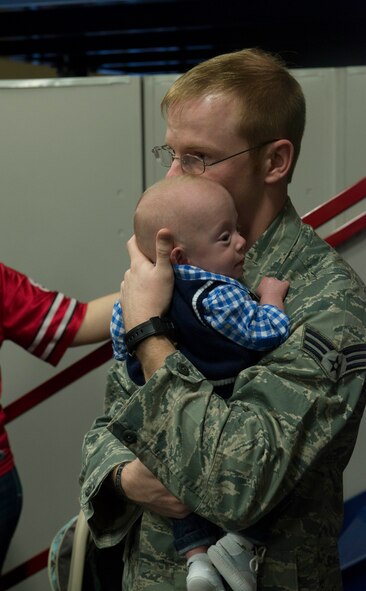 U.S. Air Force Senior Airman Timothy Martin, 824th Base Defense Squadron fire team member, hugs his son before leaving for a deployment at Moody Air Force Base, Ga., April 17, 2014. This was Martin's last goodbye to his son before leaving for his six-month deployment. (U.S. Air Force photo by Airman Dillian Bamman/Released)