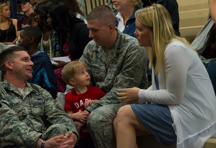 U.S. Air Force 1st Lt. Jonathan Randall, 824th Base Defense Squadron flight leader, spends time with Capt. Calvin Glass, 823d BDS operations officer, and his wife and son before departing for a deployment at Moody Air Force Base, Ga., April 17, 2014. Randall and approximately 150 Airmen left Moody for a six-month deployment to Southwest Asia. (U.S. Air Force photo by Airman Dillian Bamman/Released)