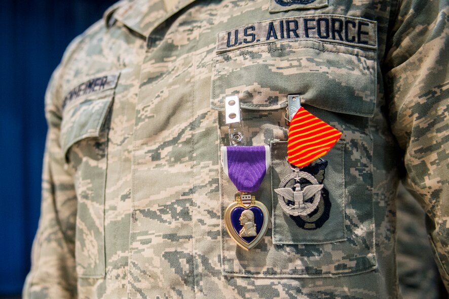U.S. Air Force Airman 1st Class Wesley Bodenheimer, 822d Base Defense Squadron fire team member, displays his Purple Heart Medal and Combat Action Medal after an award ceremony at Moody Air Force Base, Ga., April 17, 2014. Bodenheimer earned both medals during a deployment to Bagram Airfield, Afghanistan. (U.S. Air Force photo by Airman 1st Class Ryan Callaghan/Released)