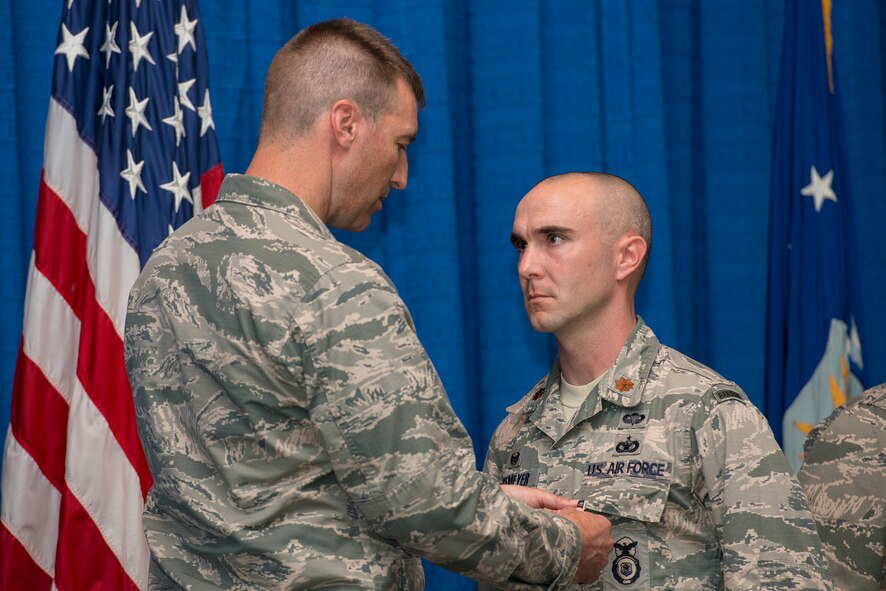 U.S. Air Force Maj. Christopher Hagemeyer, right, 822d Base Defense Squadron commander, is awarded the Bronze Star Medal by Col. Paul Kasuda, 820th Base Defense Group commander,  at Moody Air Force Base, Ga., April 17, 2014. Hagemeyer earned the BSM while assigned to the 455th Expeditionary Base Defense Squadron at Bagram Airfield, Afghanistan. (U.S. Air Force photo by Airman 1st Class Ryan Callaghan/Released)