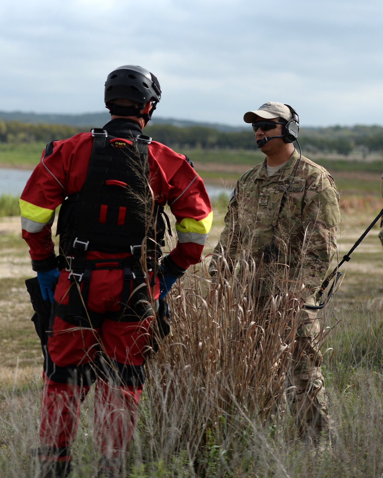 A tactical air control party member from the 147th Air Support Operations Squadron, 147th Reconnaissance Wing, based at Ellington Field Joint Reserve Base in Houston, Texas, discusses the search and rescue mission with a member from the Federal Emergency Management Agency's Texas Task Force 1 during a search and rescue exercise at Canyon Lake, Texas, April 11, 2014. The joint, interagency exercise simulated emergency response following a hurricane, with members from the Texas Air National Guard, Texas Army National Guard, Texas Task Force 1, the U.S. Coast Guard and Texas Department of Public Safety integrating to form a joint response team.